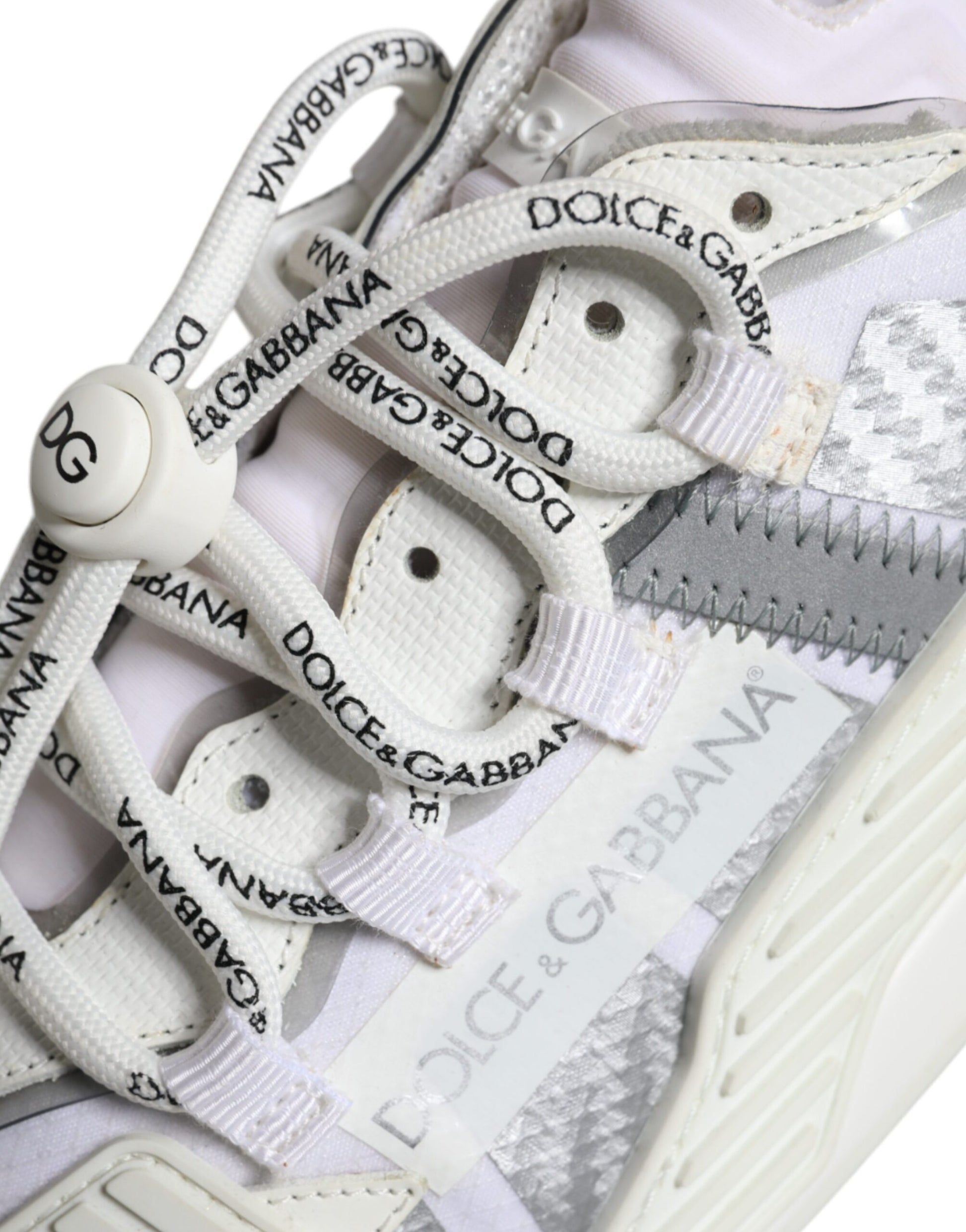 A pair of white lace-up sneakers with a low top, featuring the Dolce & Gabbana logo