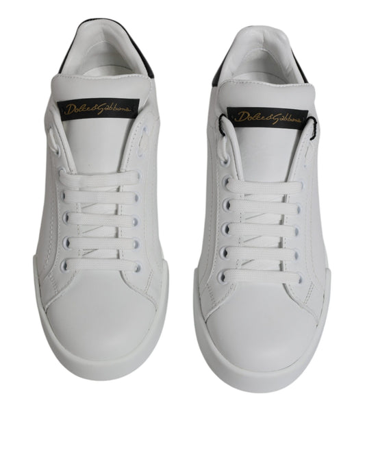 Pair of white sneakers with black laces and a logo on the side