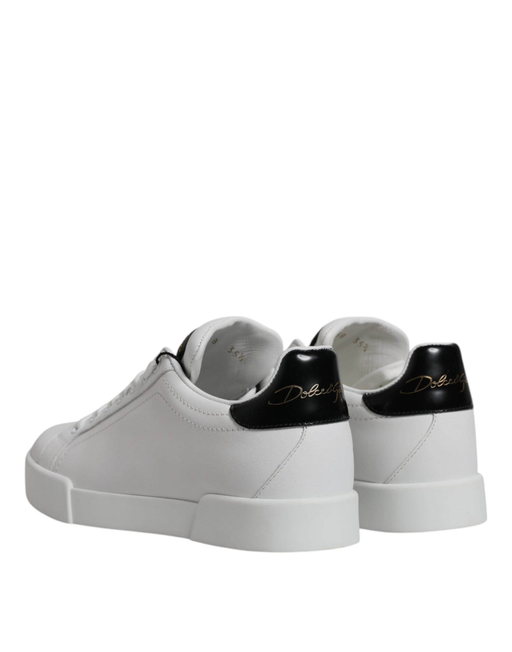 Pair of white sneakers with black laces and soles