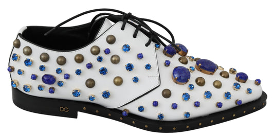 White shoe with blue and gold stones on top of it
