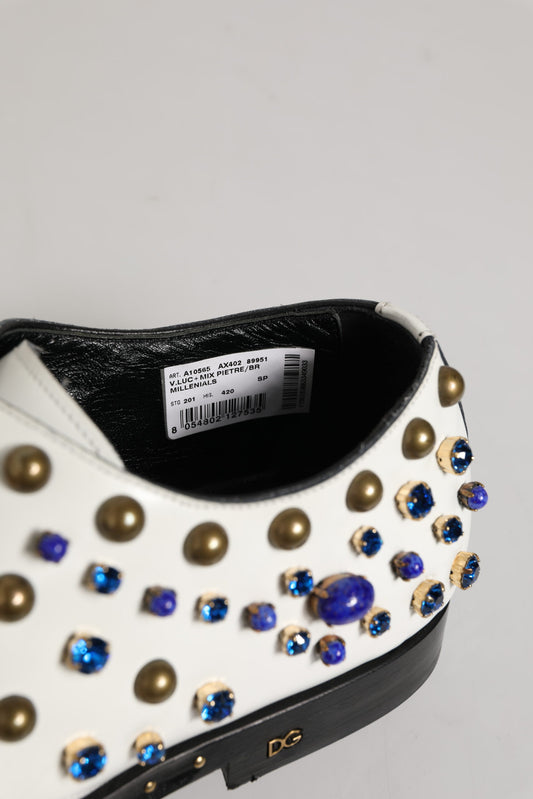 A pair of white leather shoes with crystal embellishments on the toe and heel