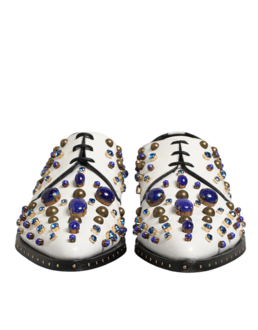 Pair of white leather dress shoes with crystal embellishments and gold accents