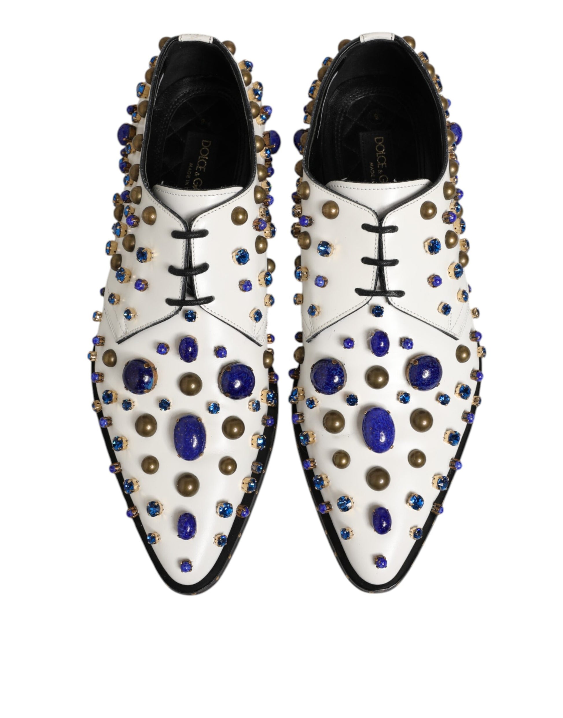 Pair of white leather shoes with blue crystal embellishments and gold accents