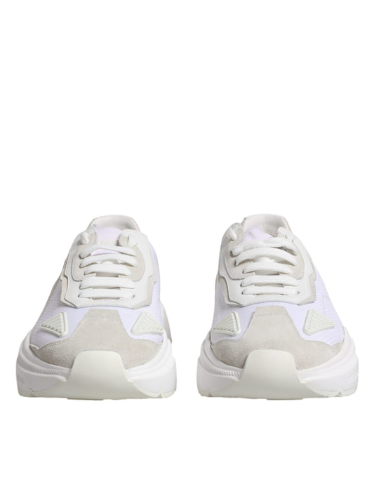 Pair of white leather sneakers with pink accents, featuring a low top design and laces