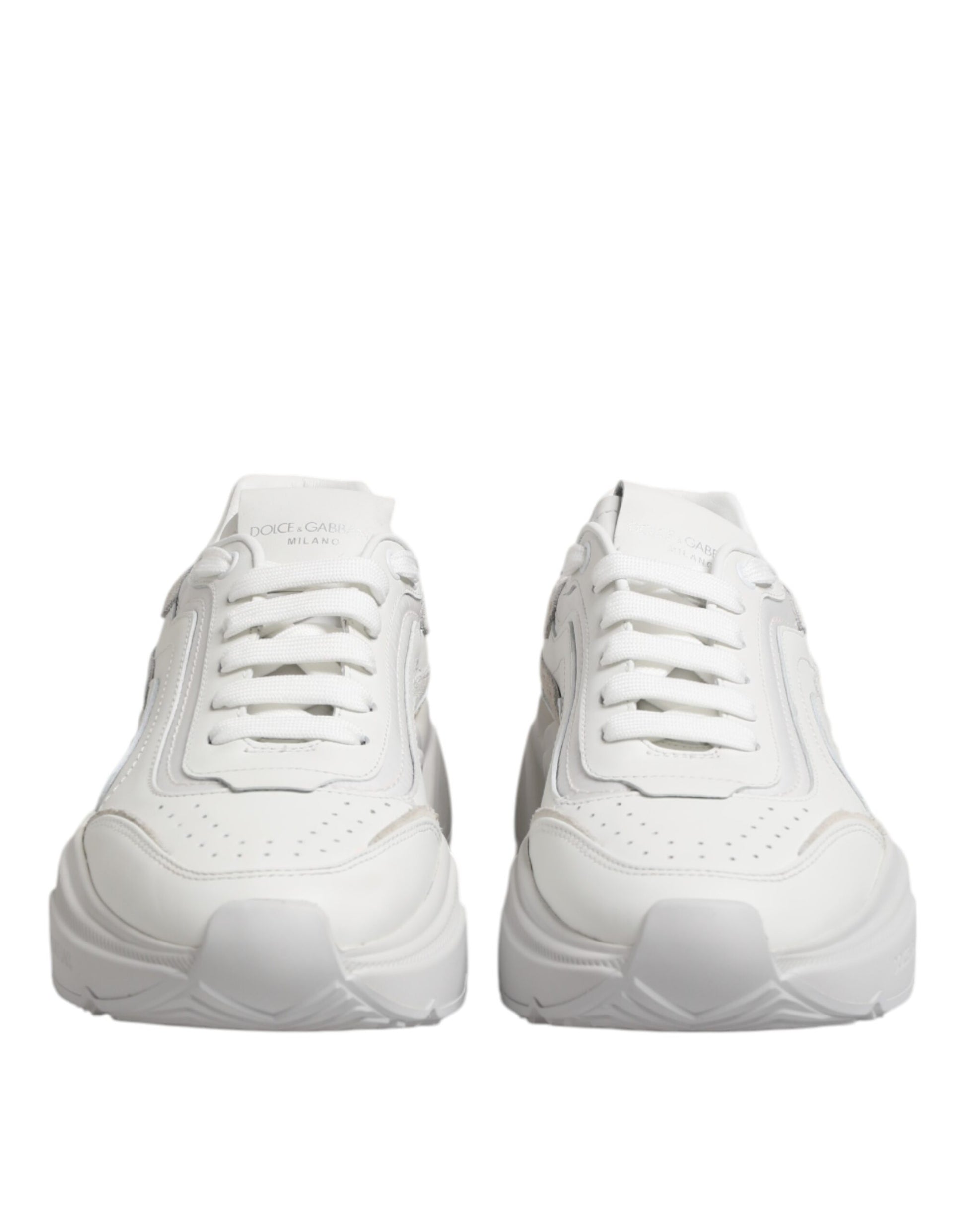 Pair of white leather sneakers with laces, featuring a low top and a logo on the side