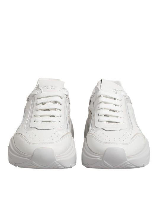 Pair of white leather sneakers with laces, featuring a low top and a logo on the side