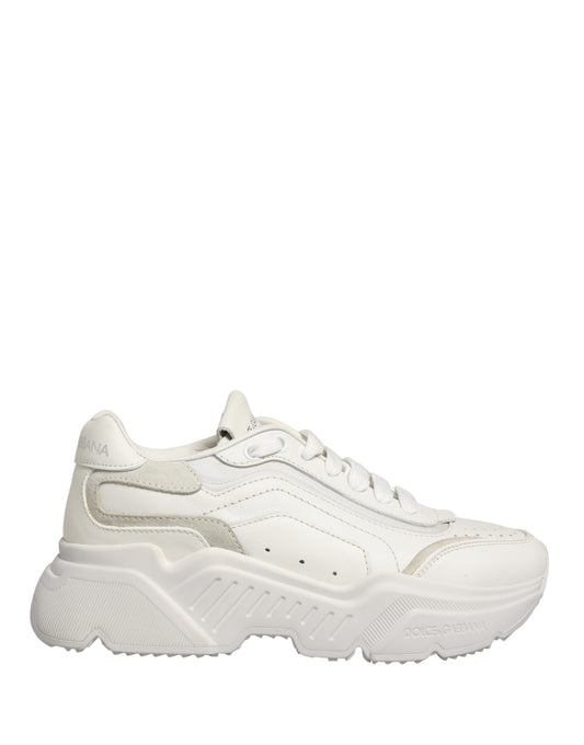 White leather sneakers with gold accents, featuring a low top design and laces