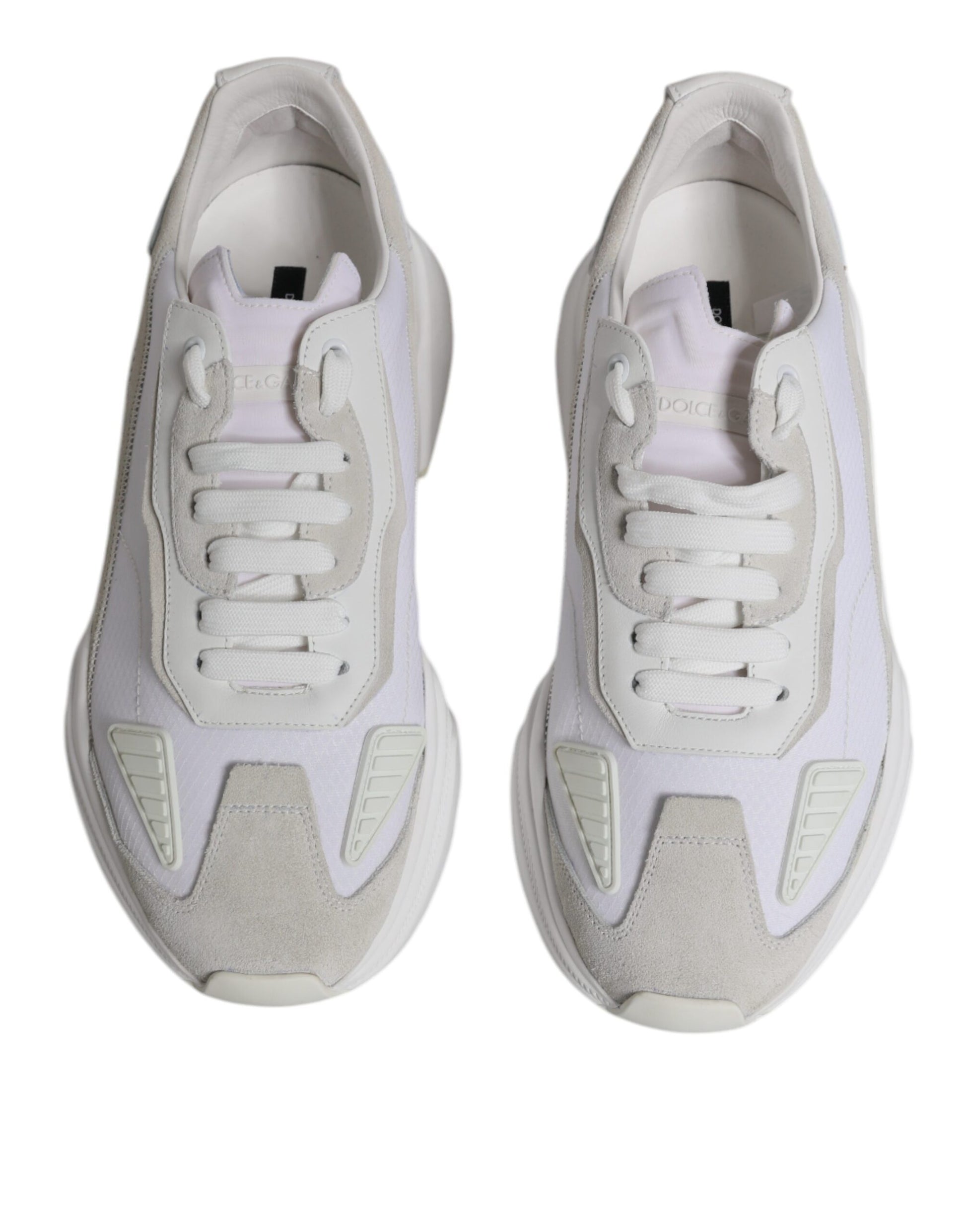 Pair of white leather sneakers with laces and a low top, featuring the brand name on the side