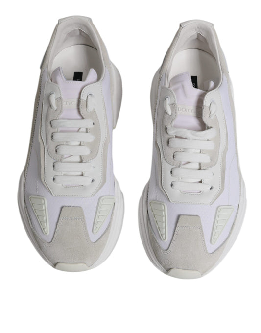 Pair of white leather sneakers with laces and a low top, featuring the brand name on the side
