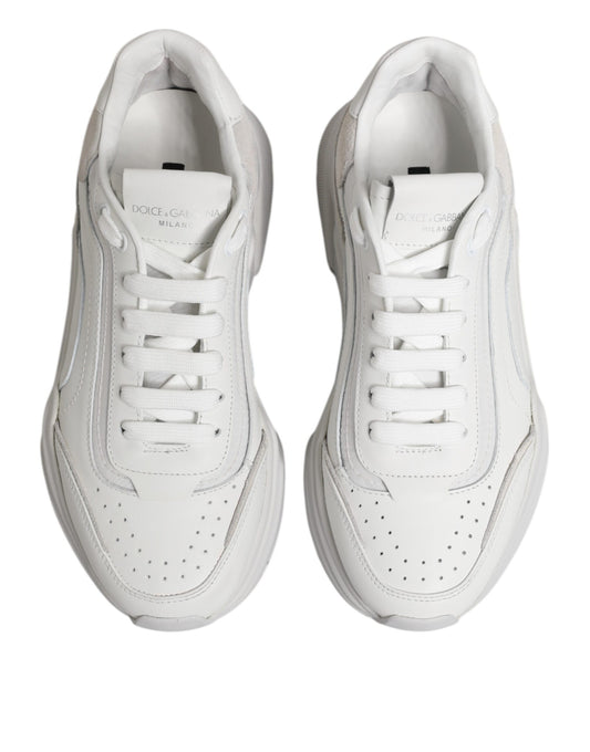 Pair of white leather sneakers with laces, featuring a low top and a logo on the side