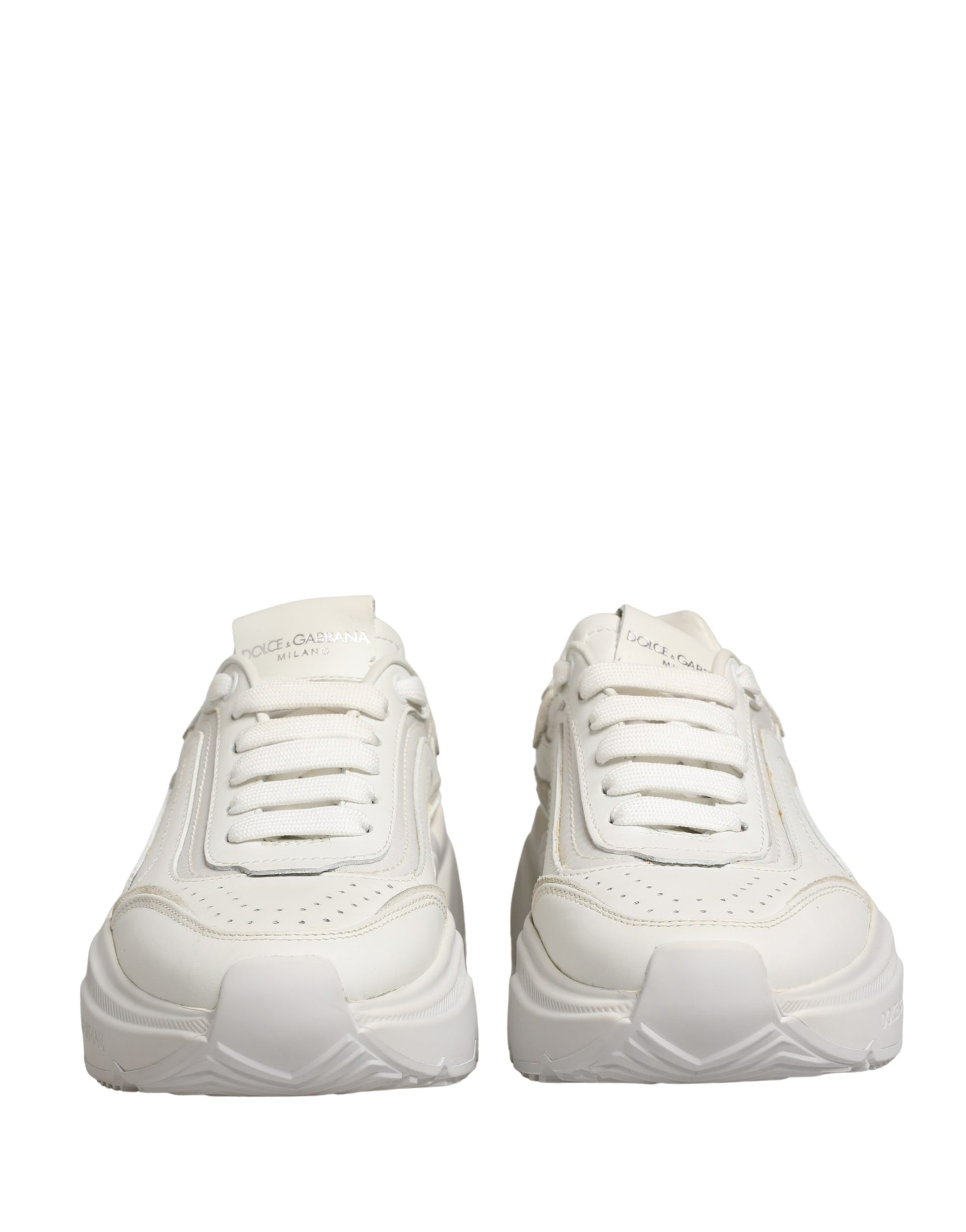 Pair of white leather sneakers with low top, featuring a lace-up front and a chunky sole design