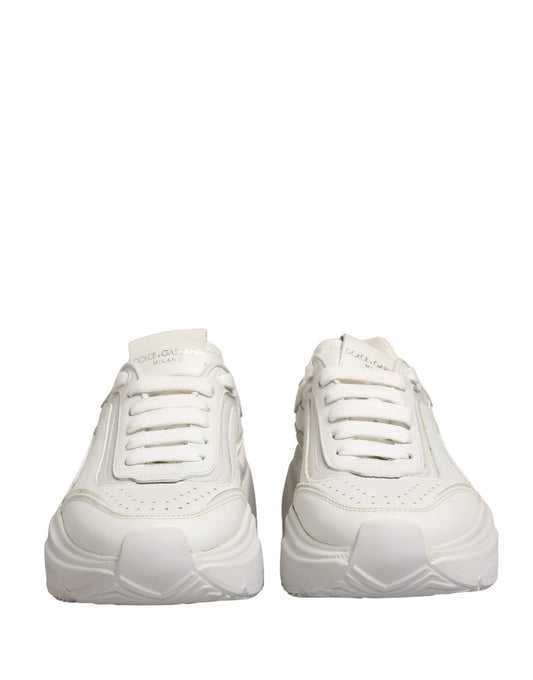 Pair of white leather sneakers with low top, featuring a lace-up front and a chunky sole design