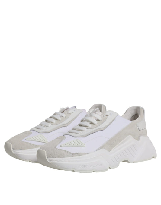 Pair of white leather sneakers with laces, featuring a low top design and a logo on the side
