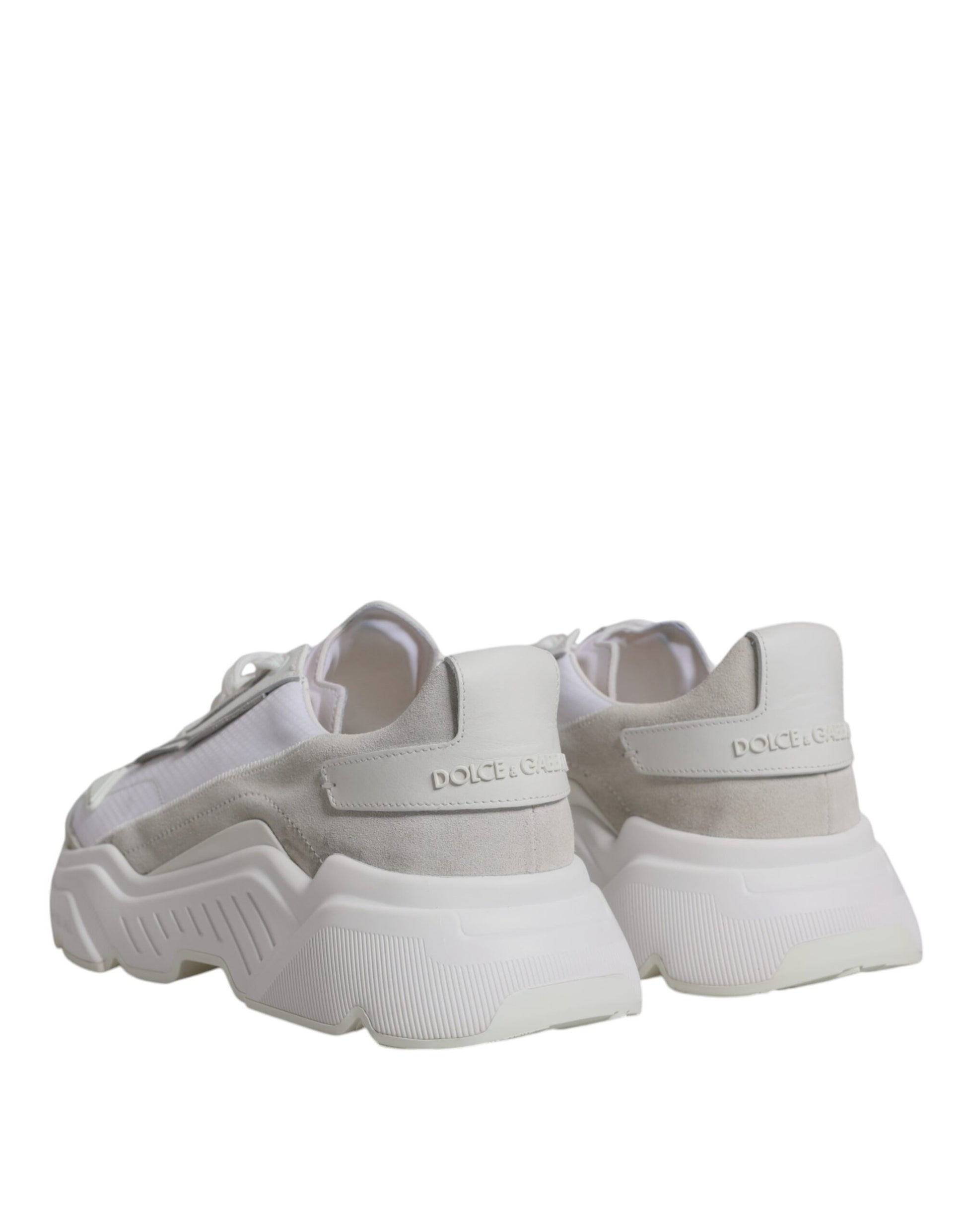 Pair of white leather sneakers with black laces and logo on side