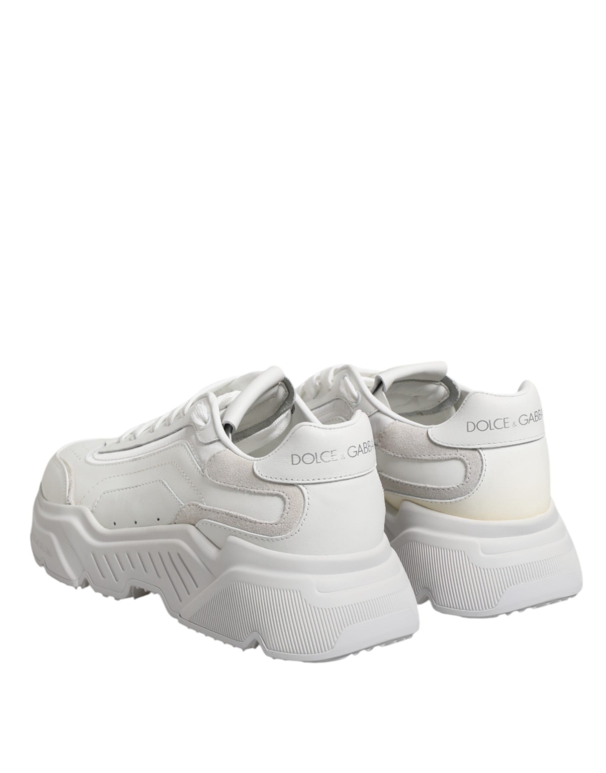 Pair of white leather sneakers with silver accents and a low top design, featuring the Dolce & Gabbana logo