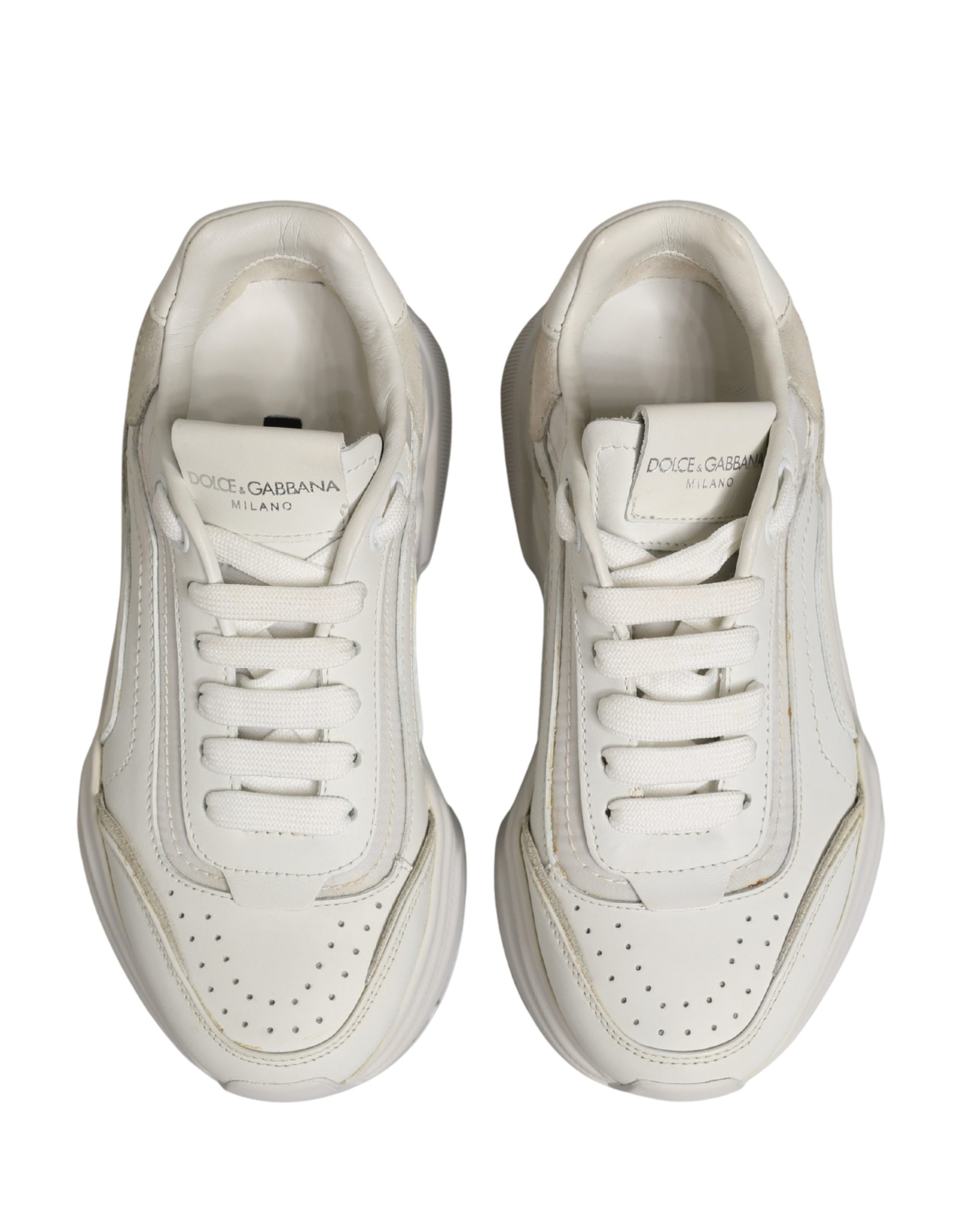 Pair of white leather sneakers with laces and a logo on the side