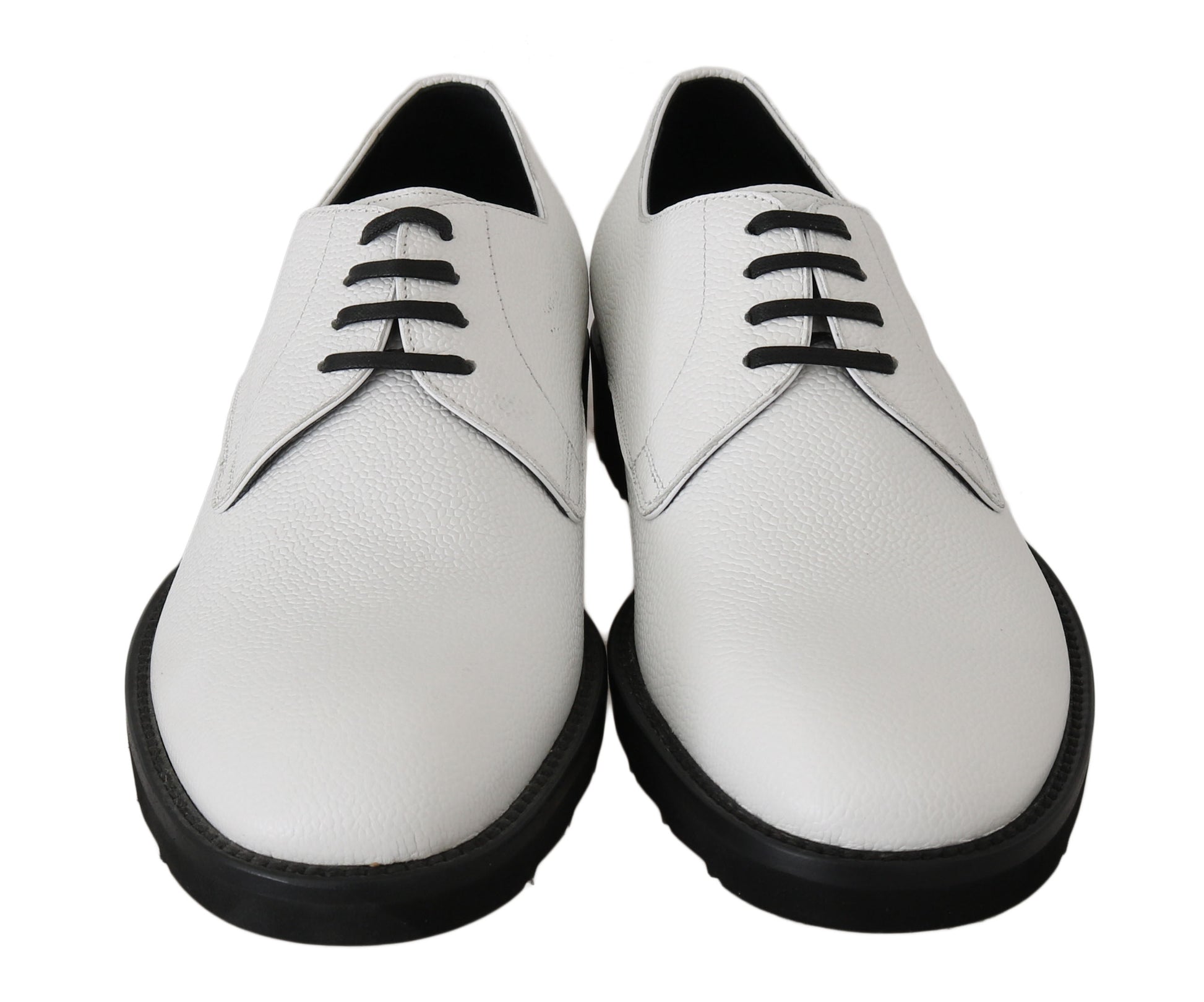 Pair of white leather shoes with black laces and soles