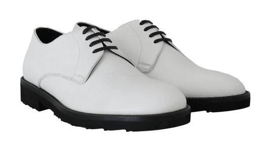Pair of white leather shoes with laces and elastic panels on sides