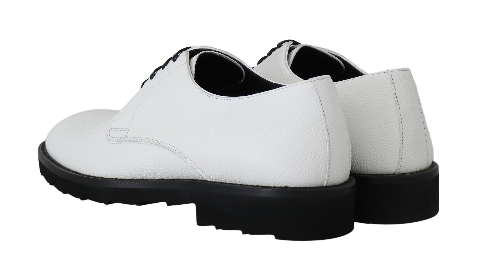 Pair of white leather shoes with black laces and soles
