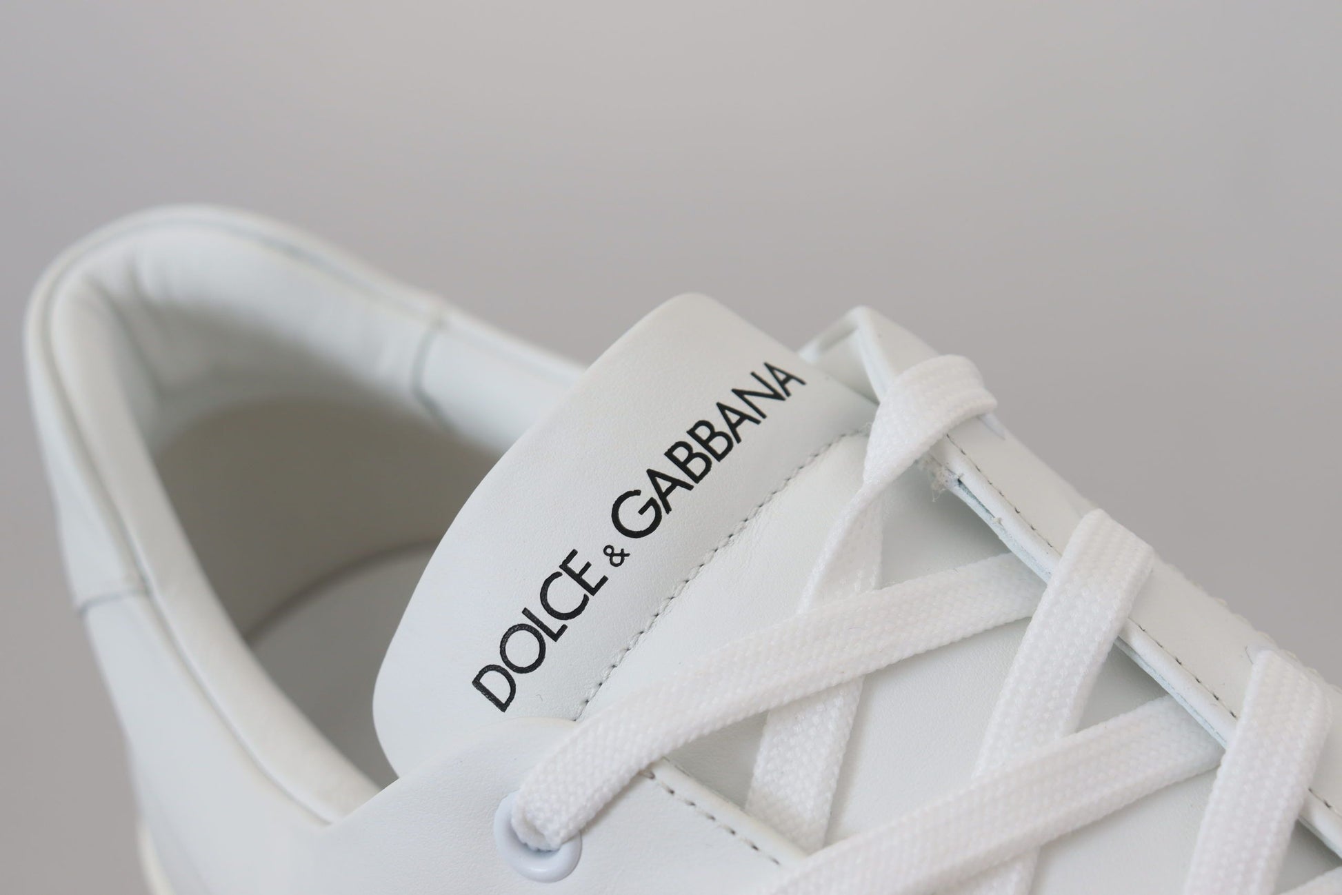 White sneaker with brand name on tongue and side