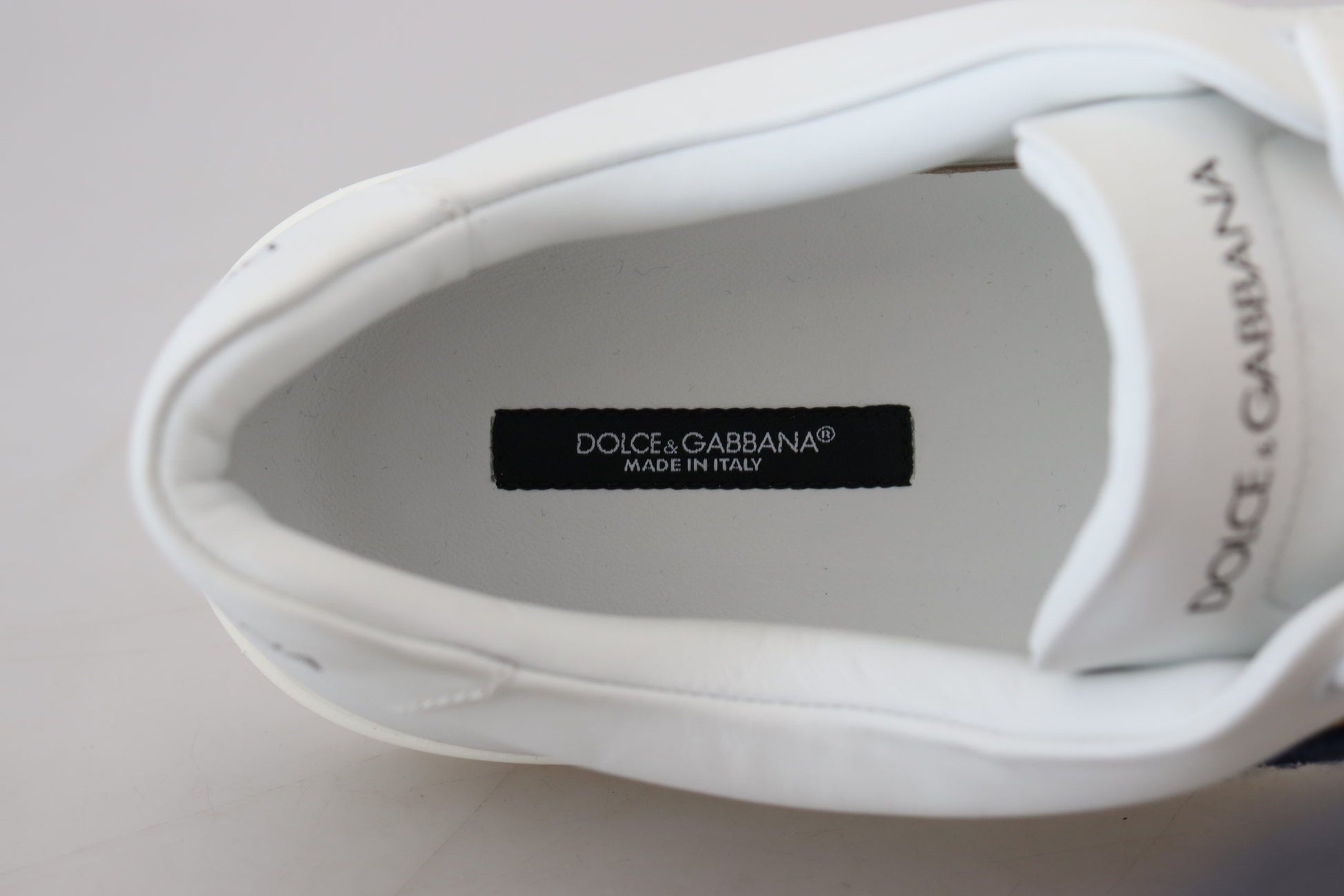 White sneaker with black label inside