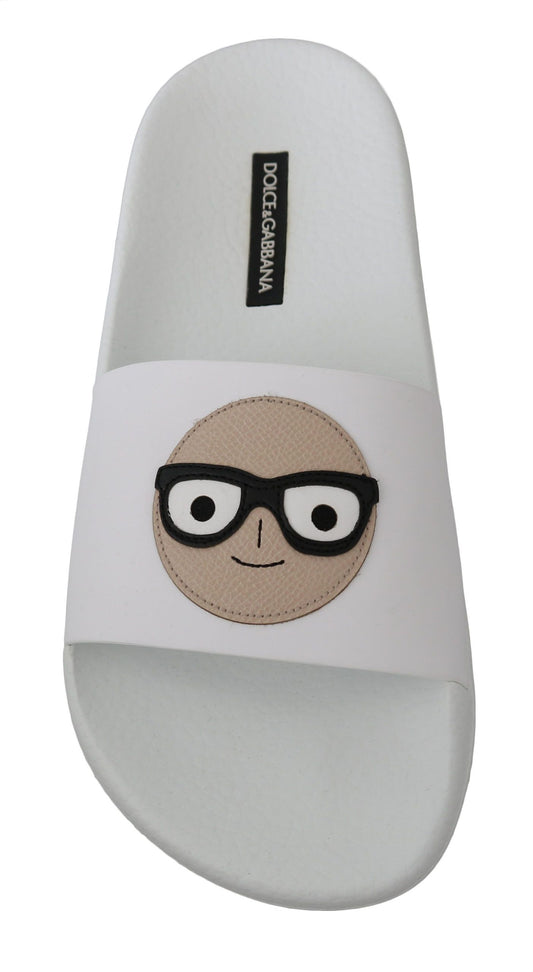 White flip flops with a cartoon face on the strap
