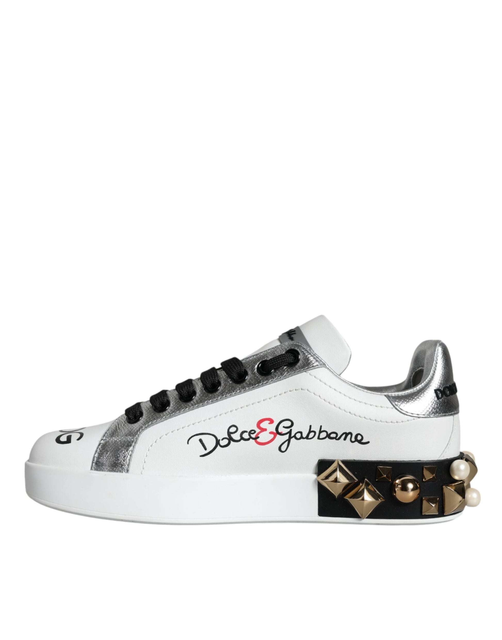 White sneaker with black laces and silver buckle. Black logo on side