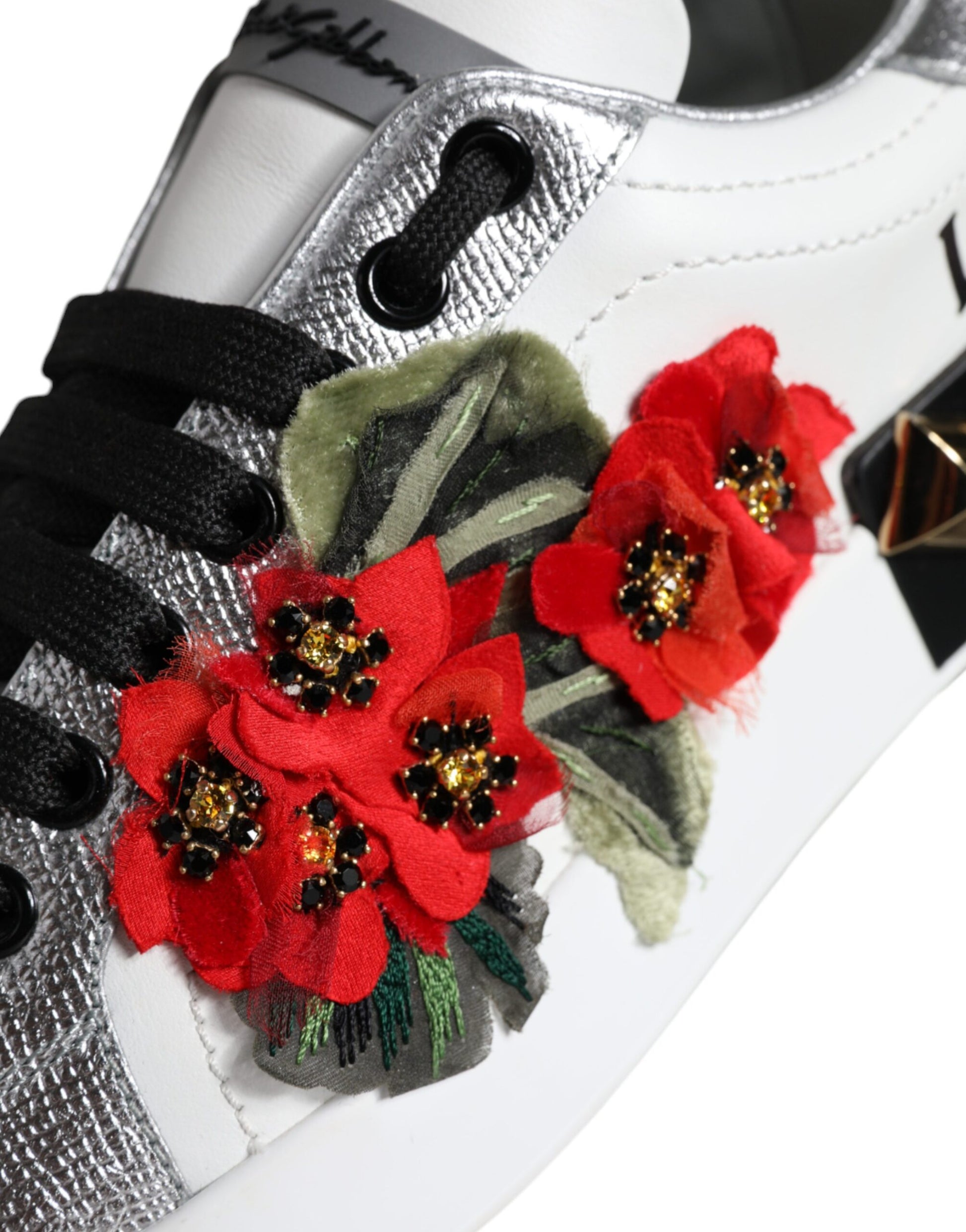 Silver and white sneaker with red flower embellishments on side