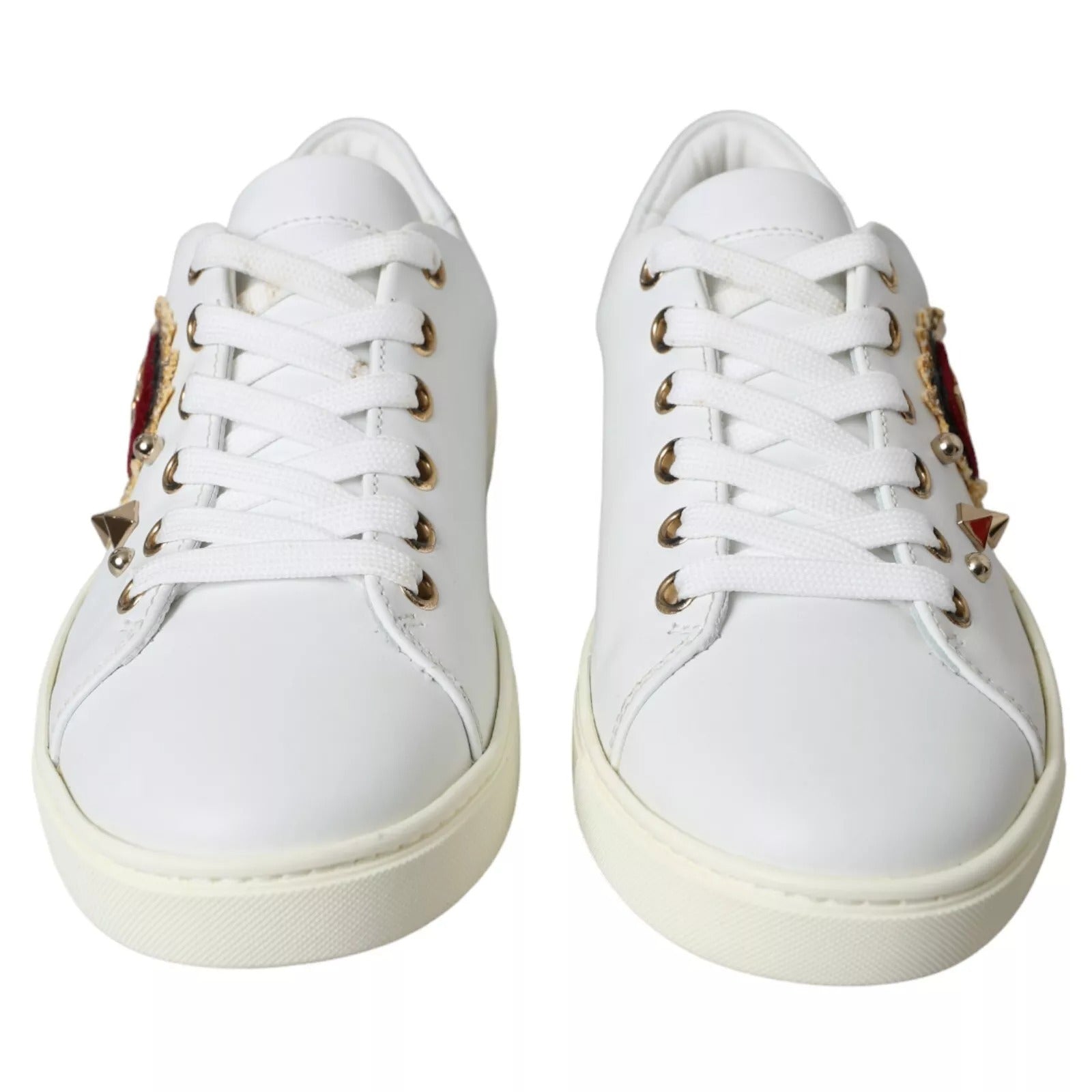 White sneakers with gold accents on laces