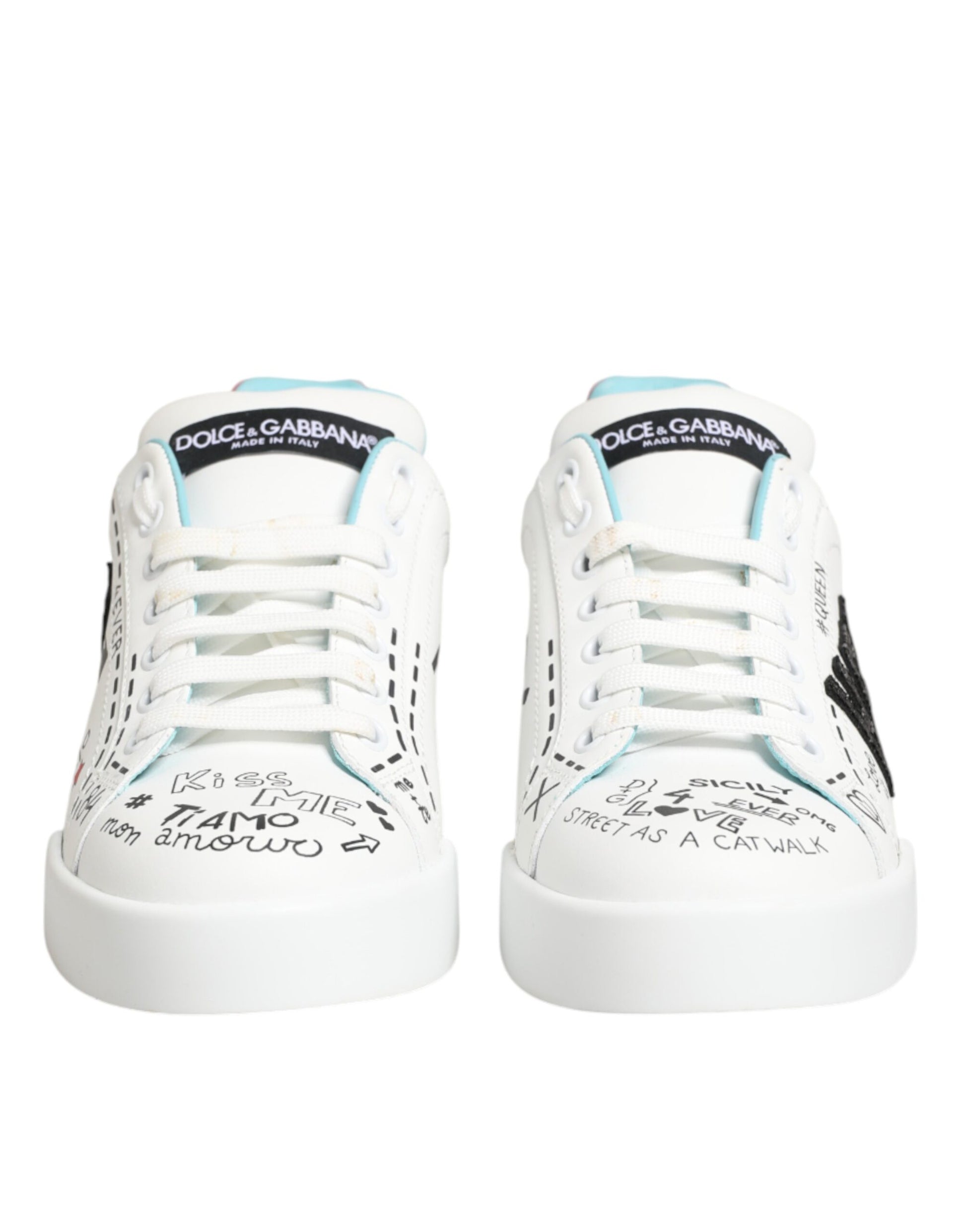 Pair of white sneakers with blue laces and writing on side