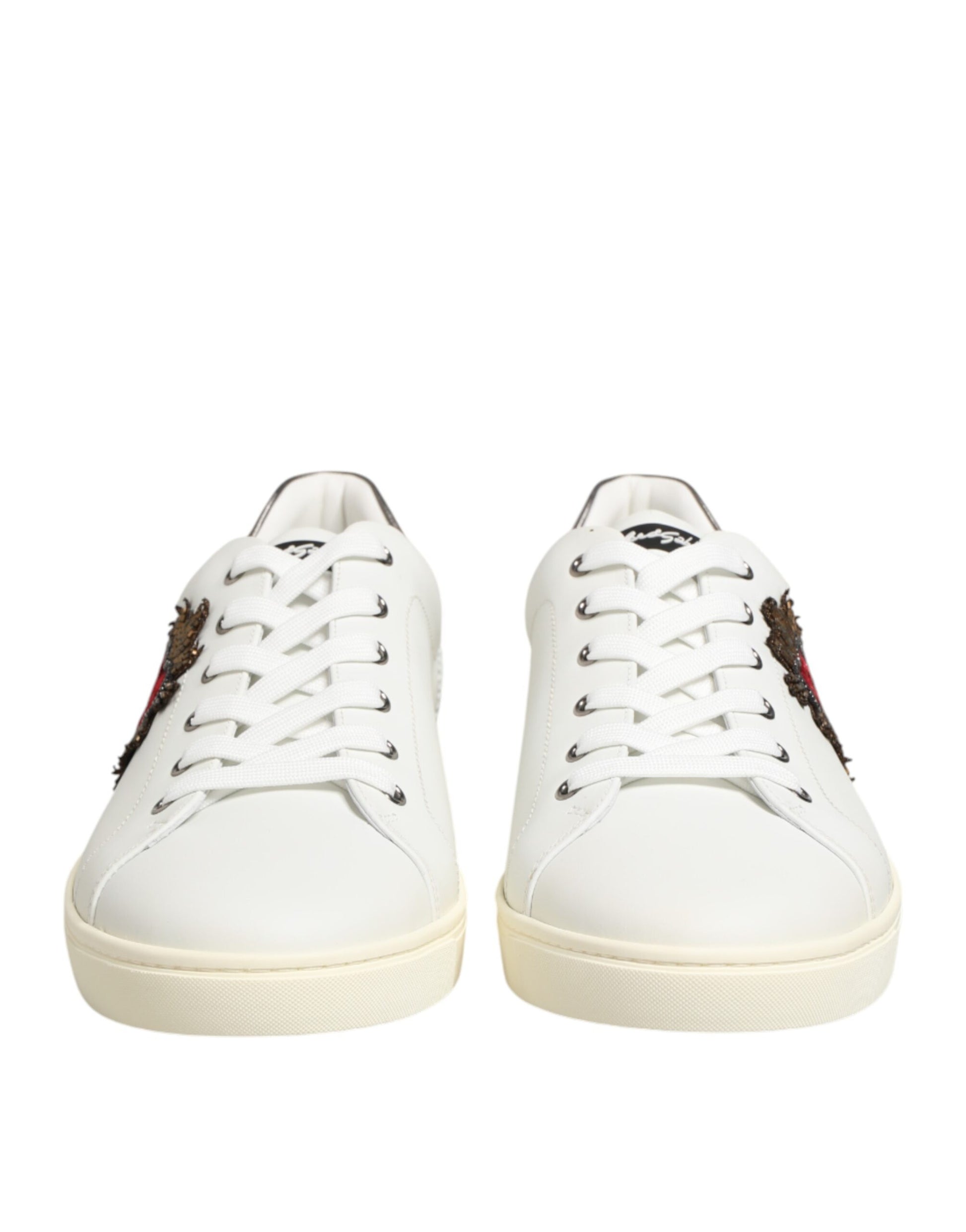 Pair of white leather sneakers with heart embellishments and laces