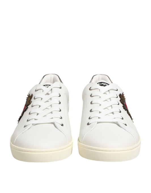 Pair of white leather sneakers with heart embellishments and laces