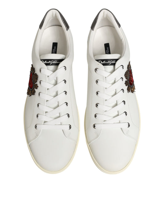 Pair of white leather sneakers with heart embellishment on side, featuring laces and flat soles