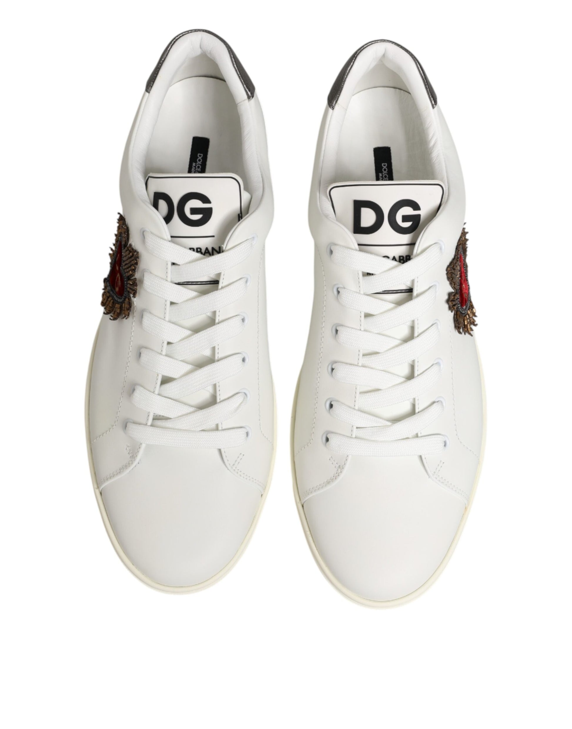 Pair of white leather sneakers with heart embellishment and brand logo on side