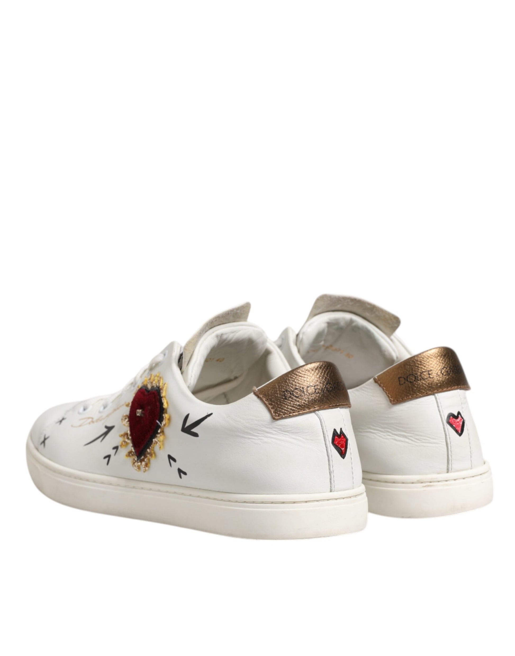 White sneakers with gold accents, heart designs, and a unique pattern on the side
