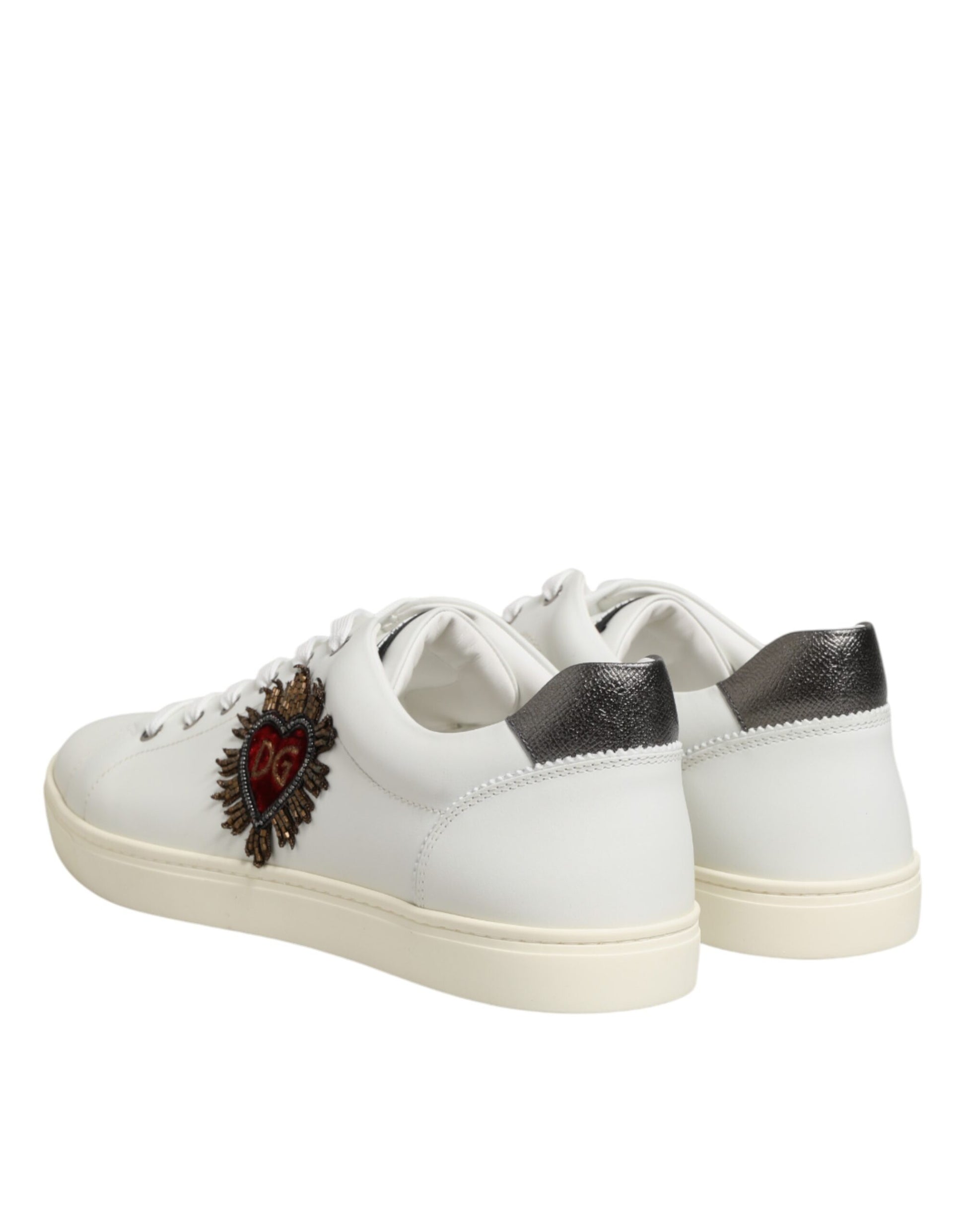 Pair of white leather sneakers with heart embellishment on side