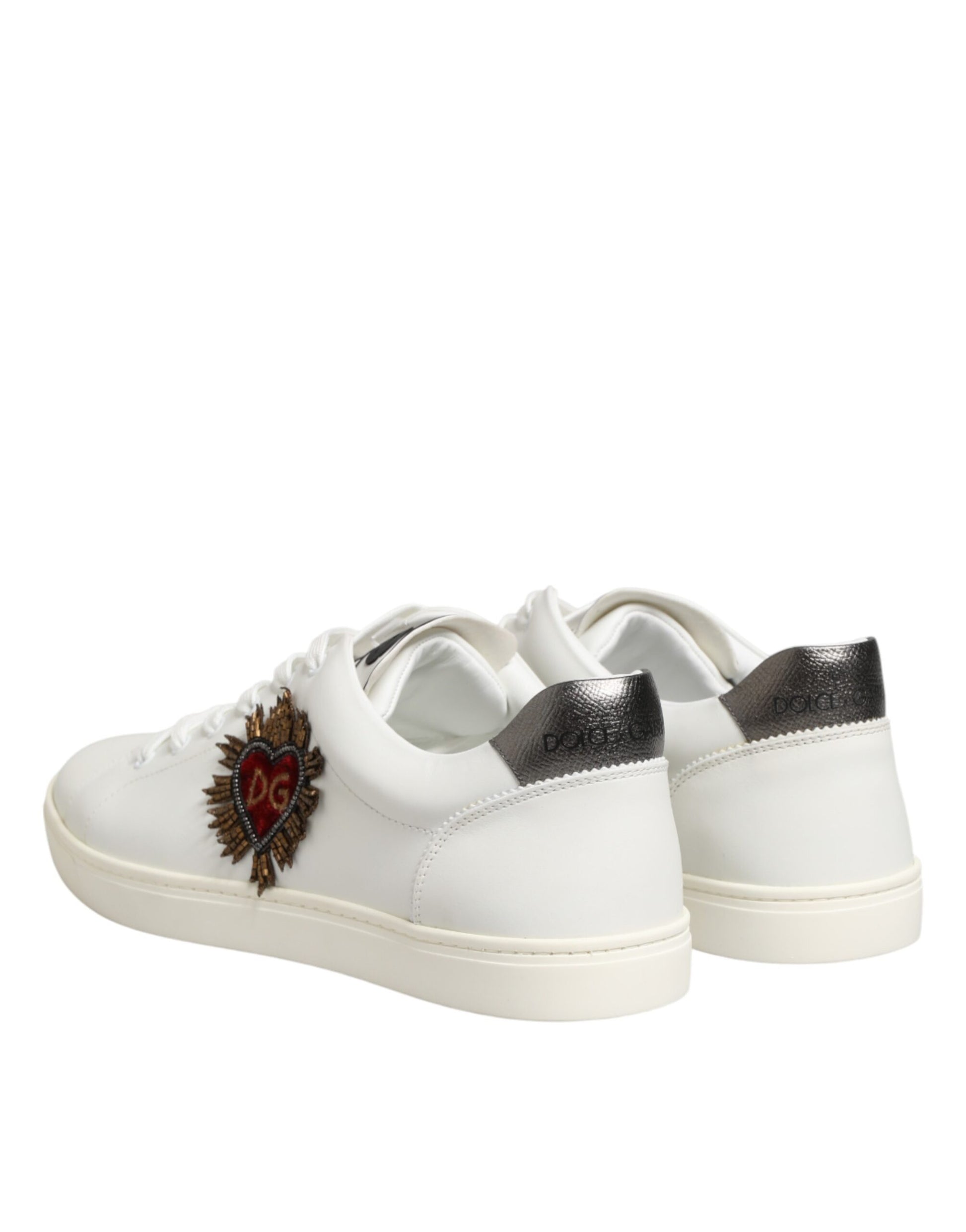 Pair of white leather sneakers with black laces and a heart embellishment