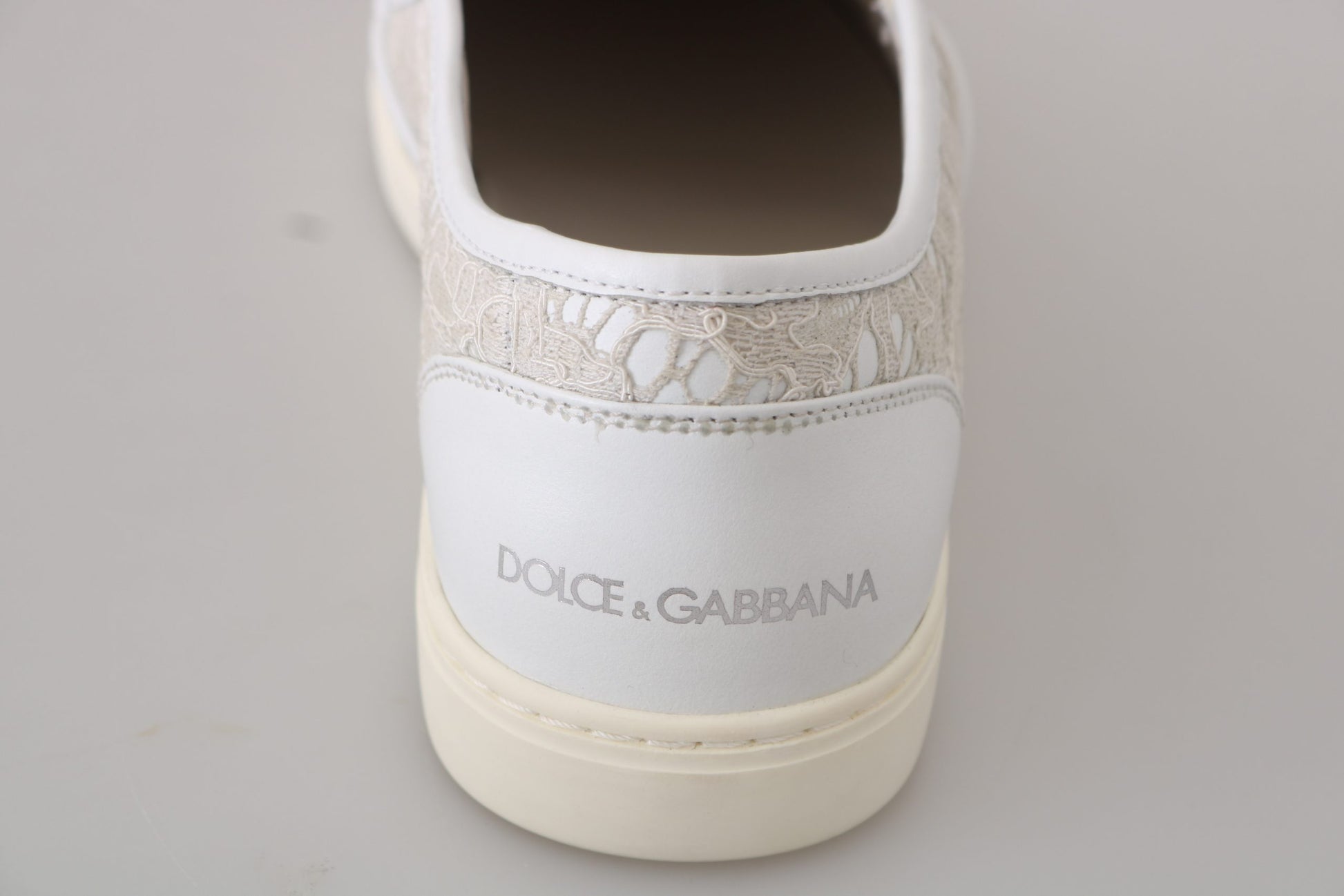 White sneaker with tan sole and embroidered logo on side