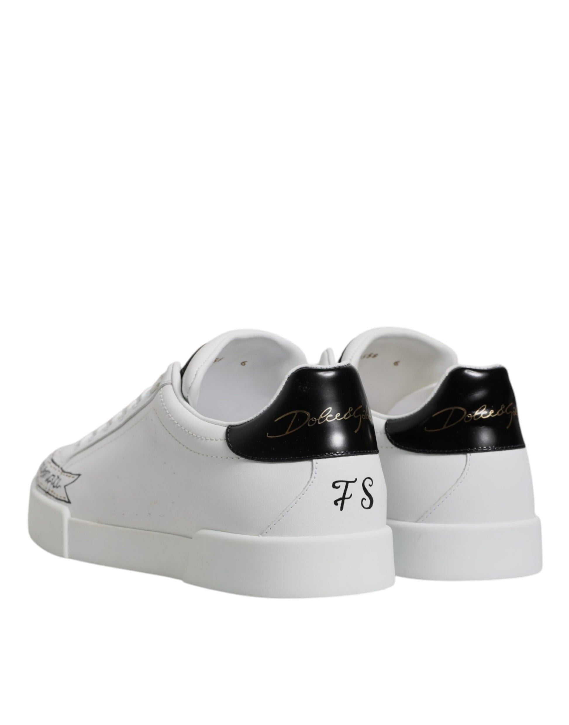 Pair of white sneakers with black laces and soles
