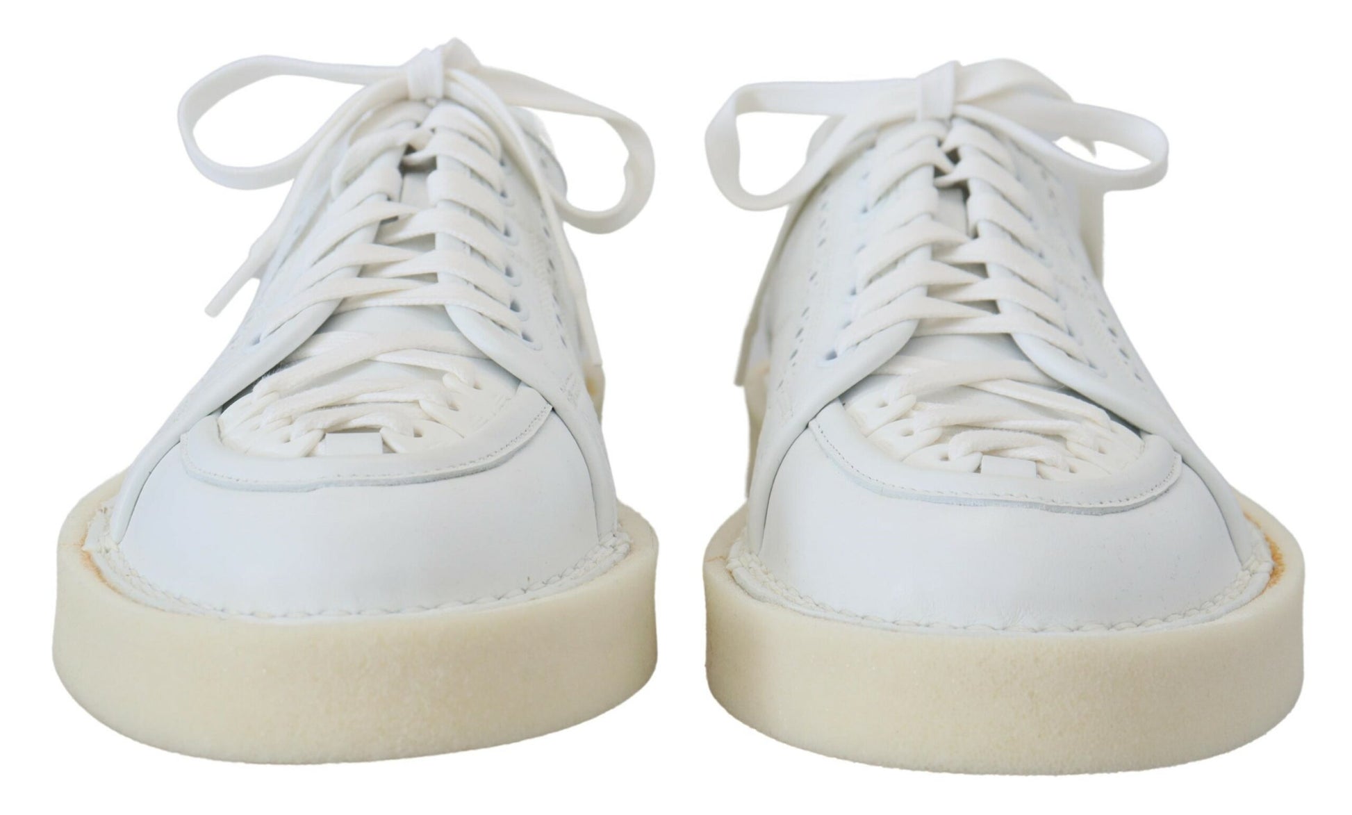 Pair of white sneakers with tan soles and laces