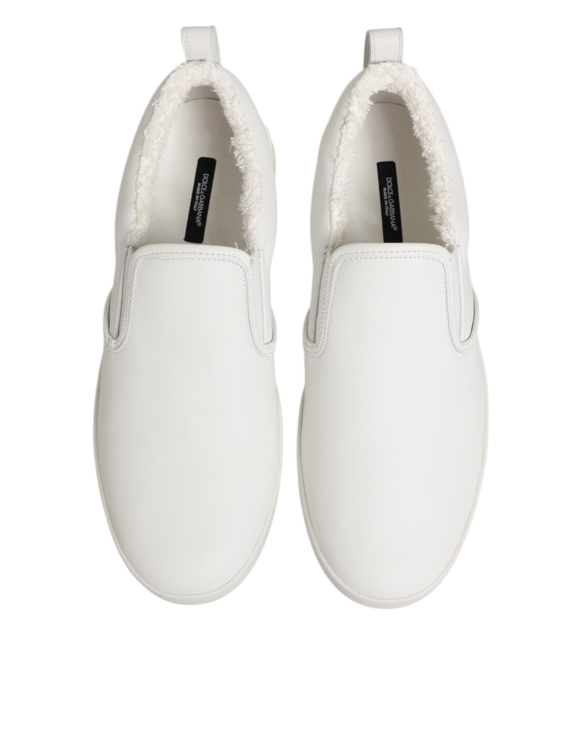 Pair of white leather slip-on shoes with a low top, featuring a textured design on the sides