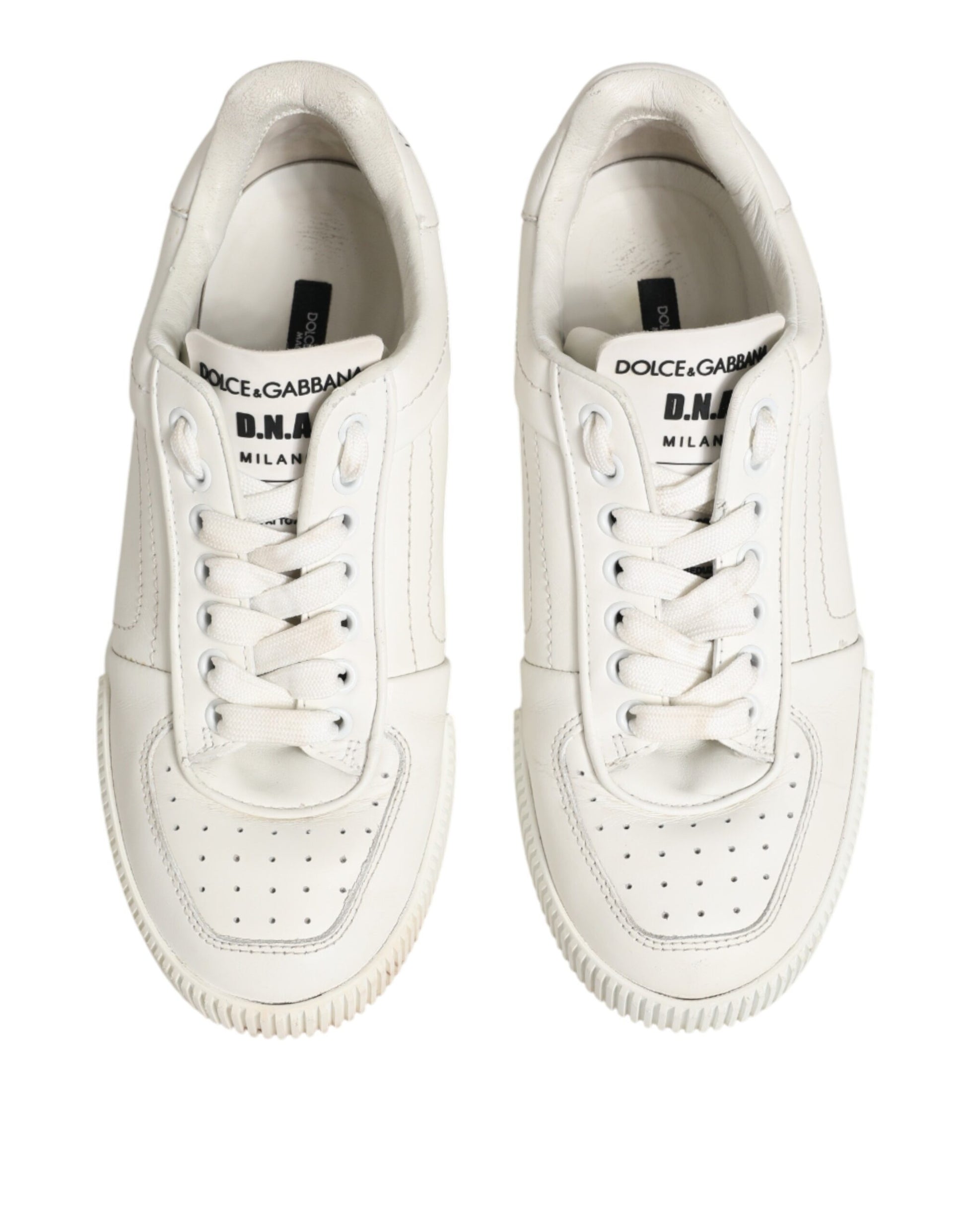 Pair of white sneakers with black laces