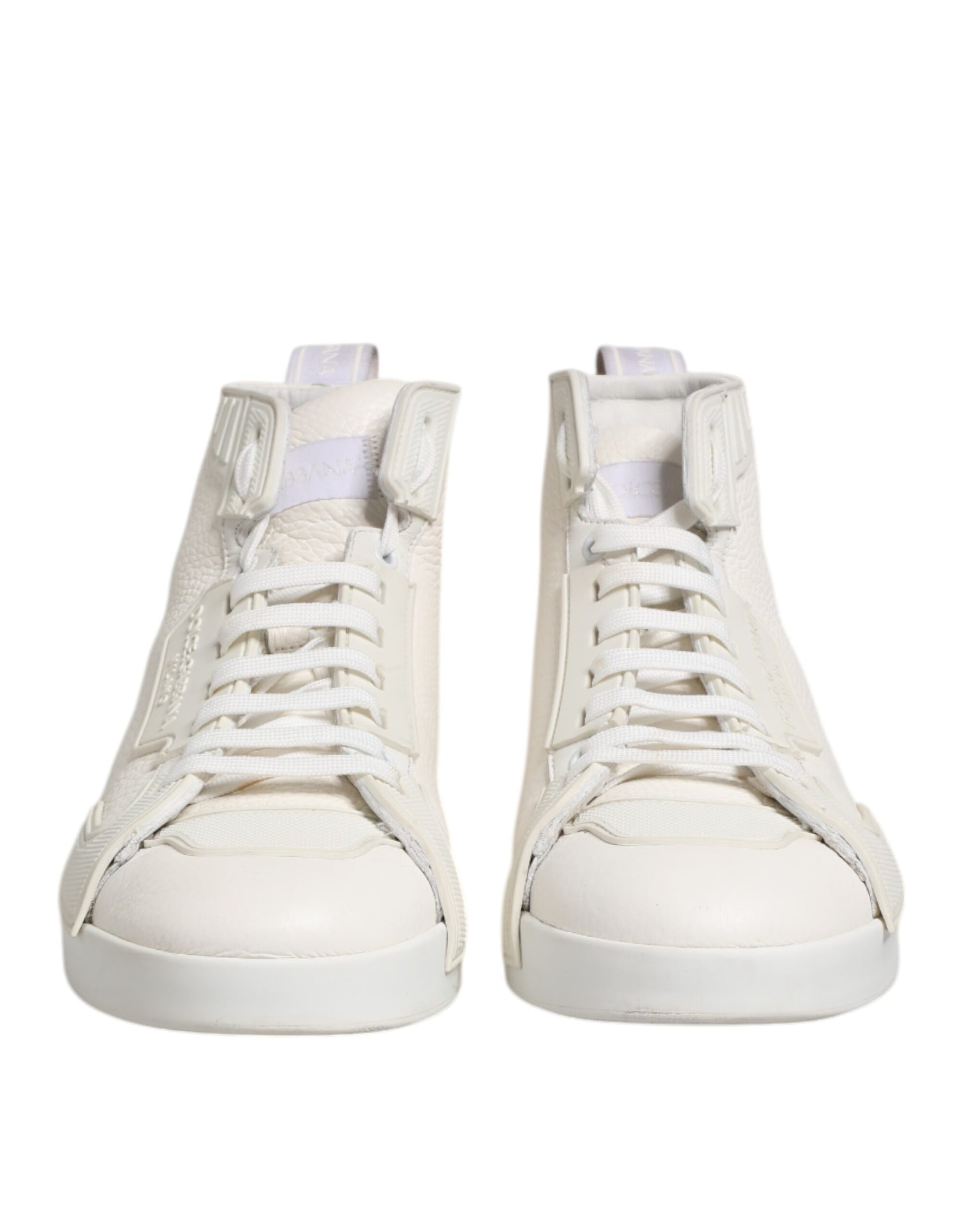 Pair of white leather mid top sneakers with laces and a small logo on the side