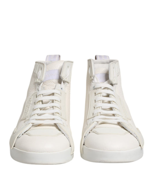 Pair of white leather mid top sneakers with laces and a small logo on the side