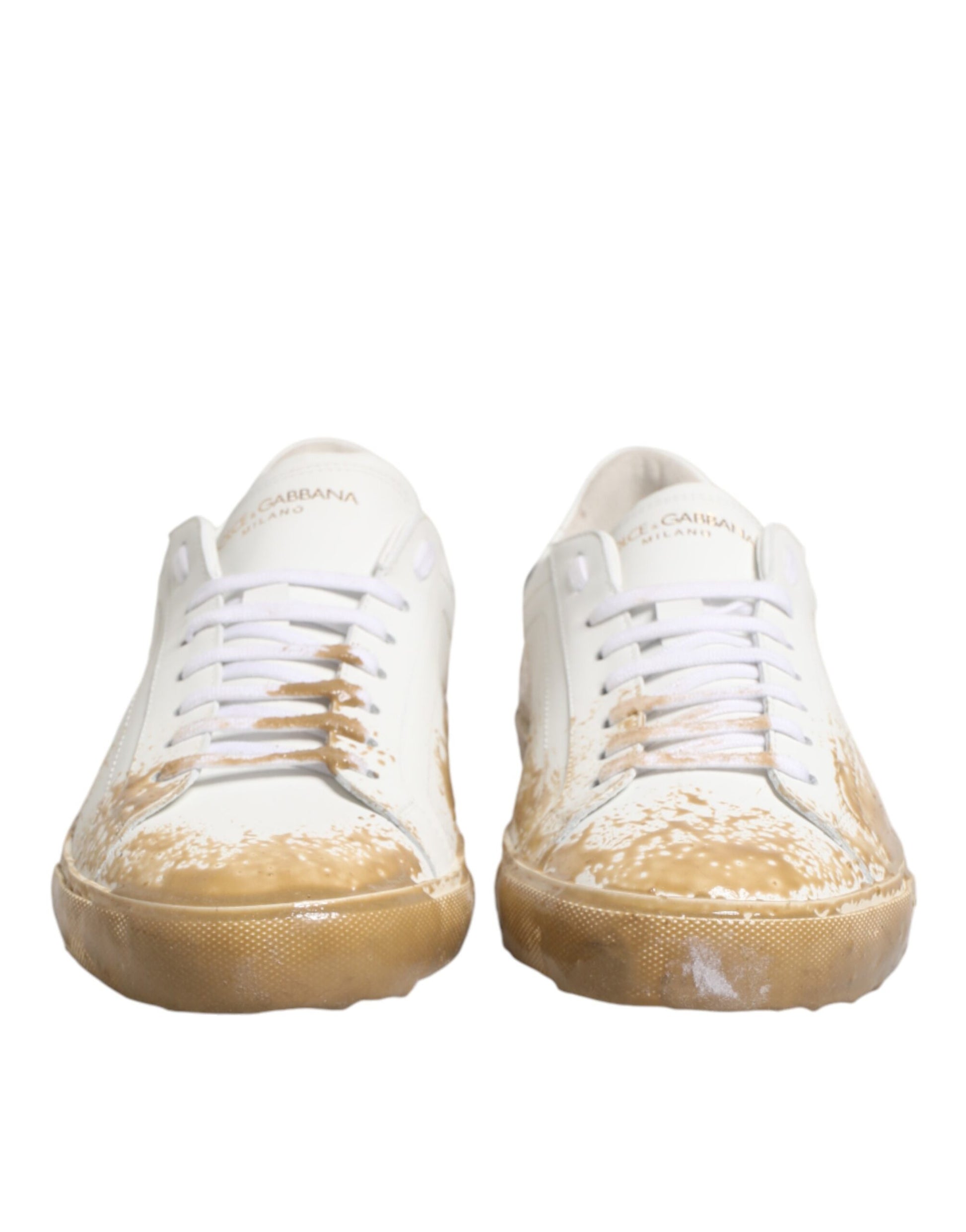 Pair of dirty white sneakers with yellow soles