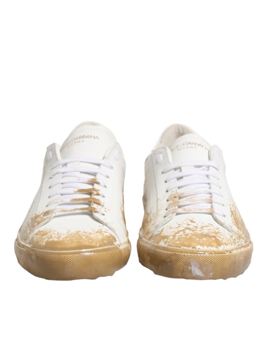 Pair of dirty white sneakers with yellow soles