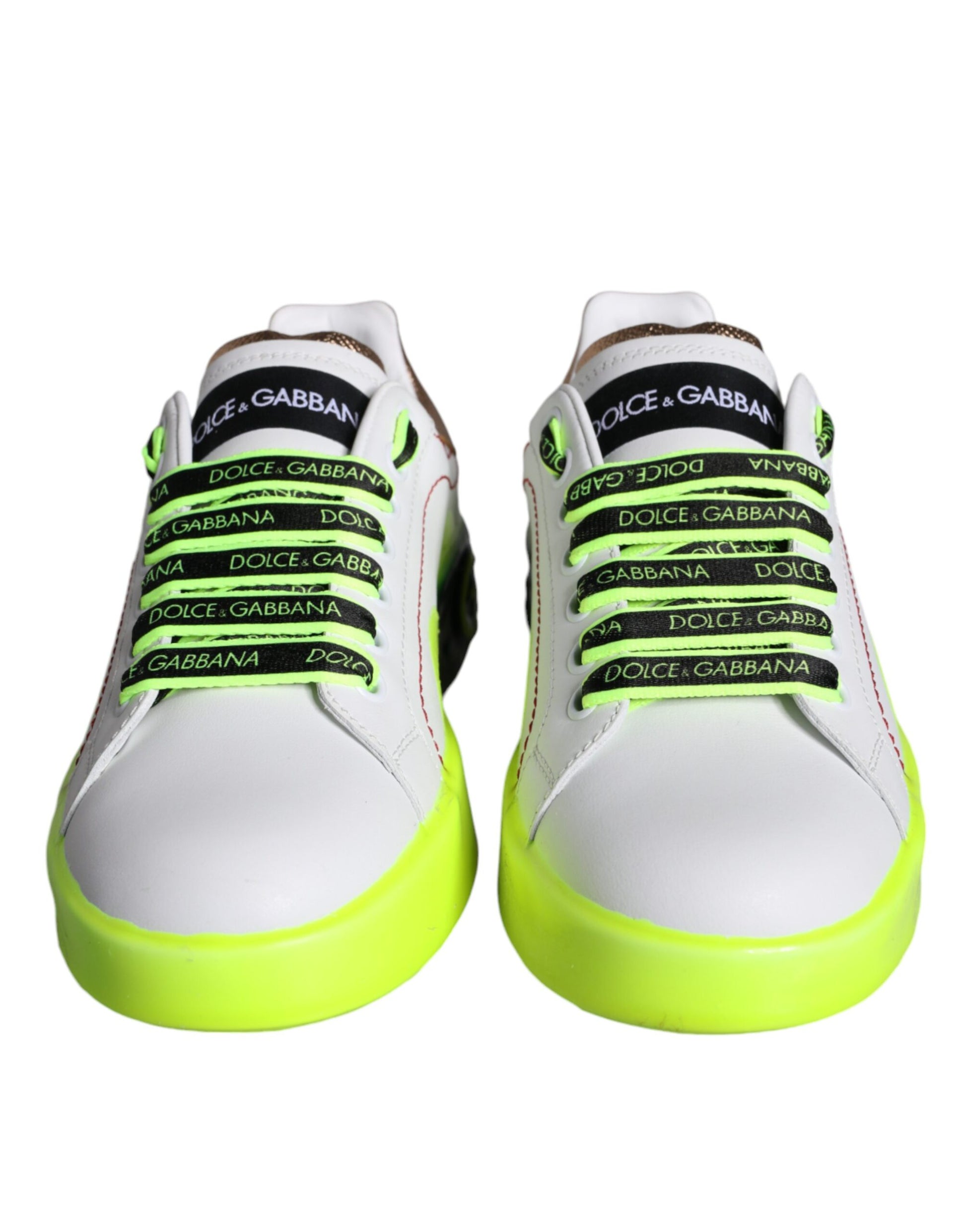 Pair of white sneakers with yellow and green accents