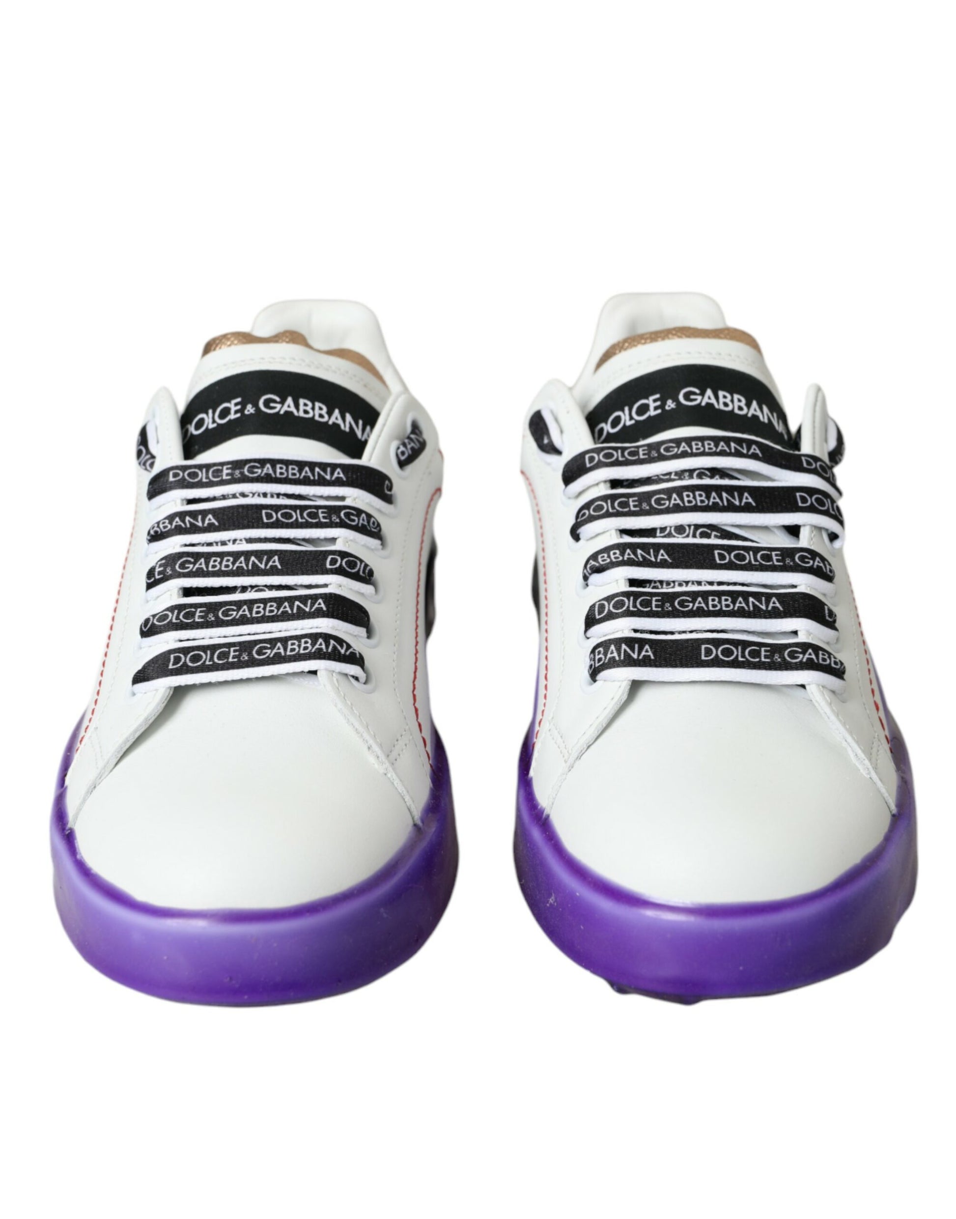 Pair of white sneakers with purple soles and black laces