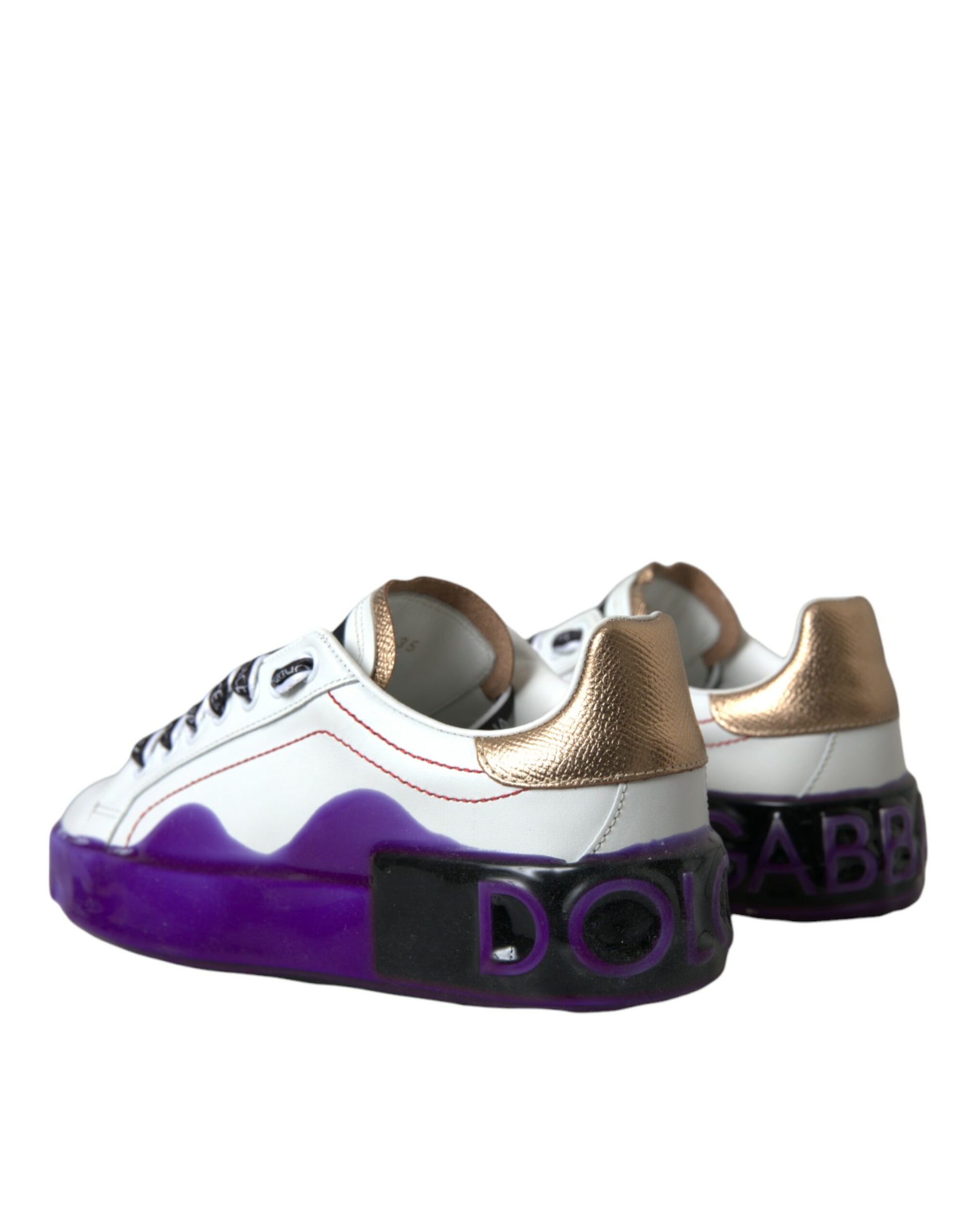 Pair of baby shoes with gold accents and purple laces