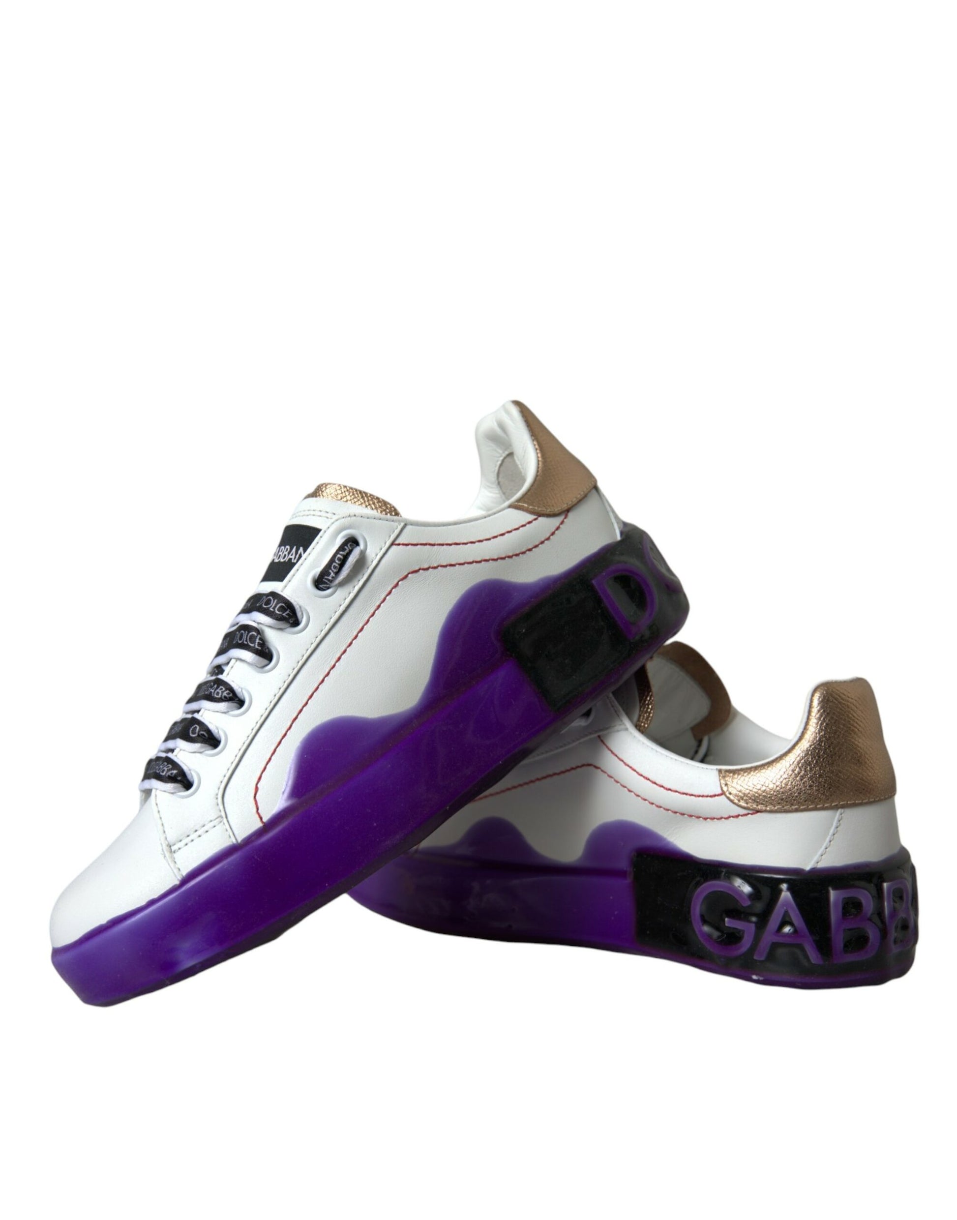 Pair of sneakers with purple and white design on upper part, gold accents, and black laces